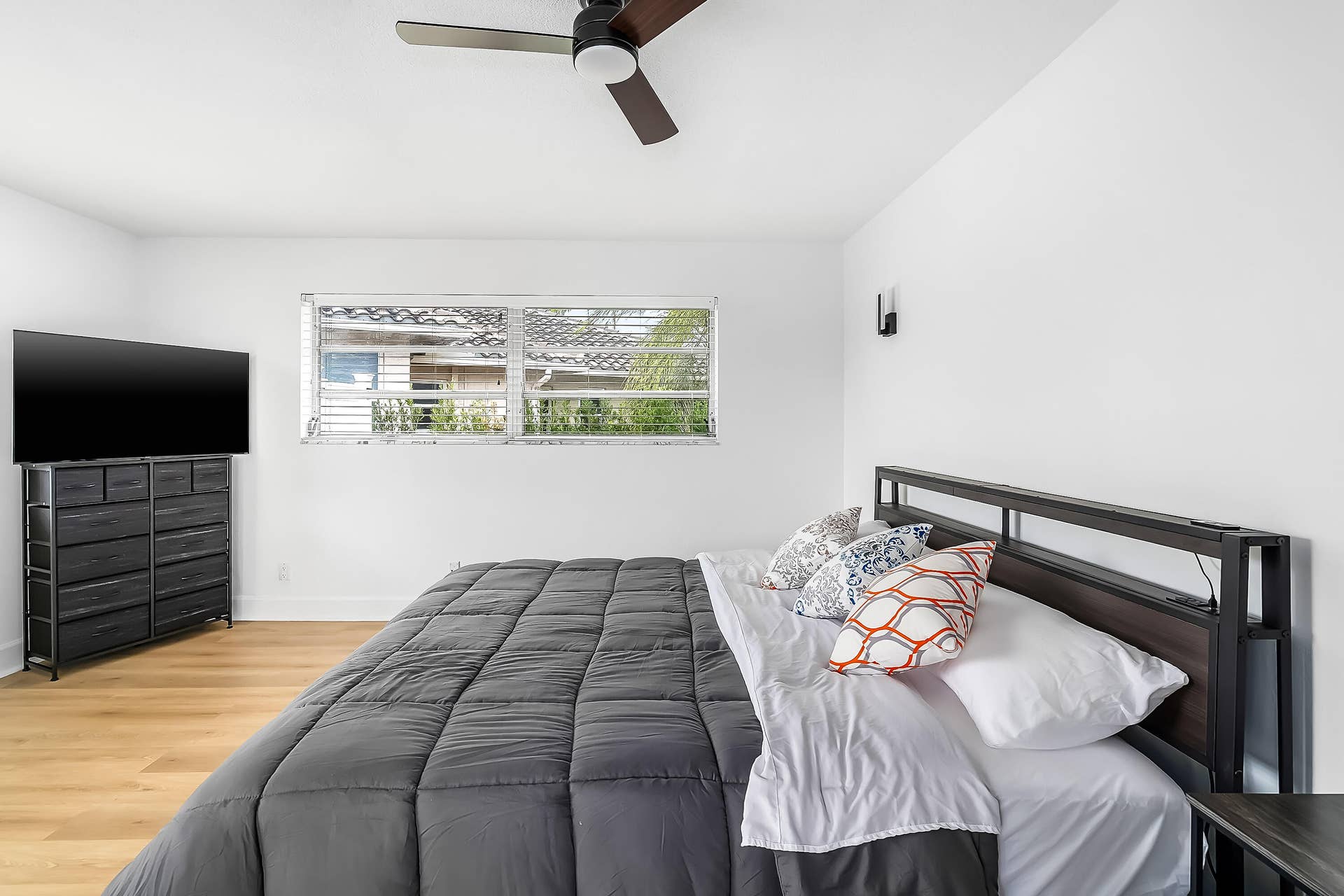 1250 SE 10TH Street, Deerfield Beach, Deerfield Beach, FL 33441 Interior room featuring wood-finish flooring, a ceiling fan with integrated lighting, and a horizontal window with blinds