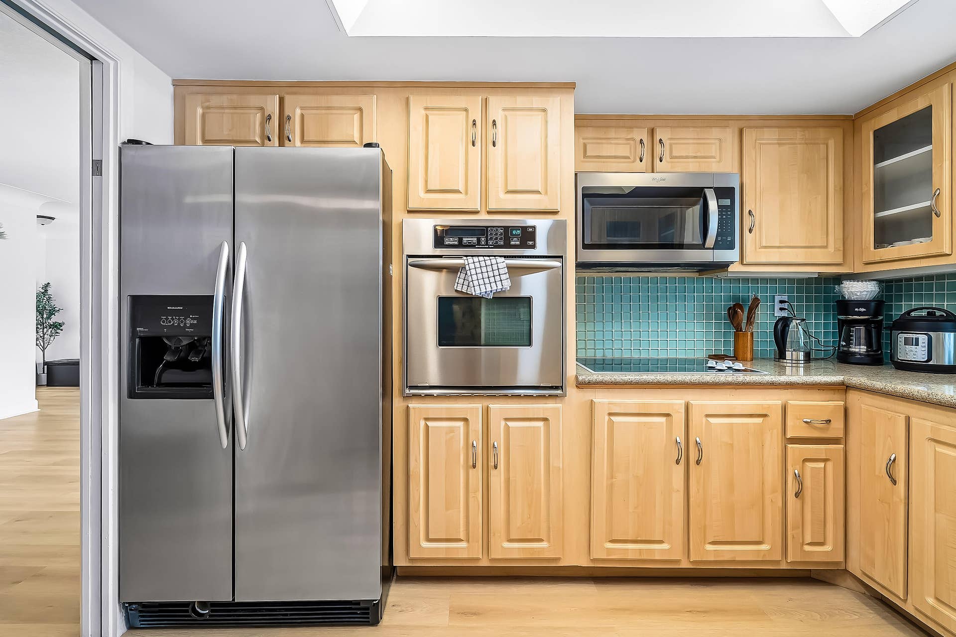 1250 SE 10TH Street, Deerfield Beach, Deerfield Beach, FL 33441 Kitchen featuring light wood cabinetry, stainless steel appliances, and a blue mosaic tile backsplash