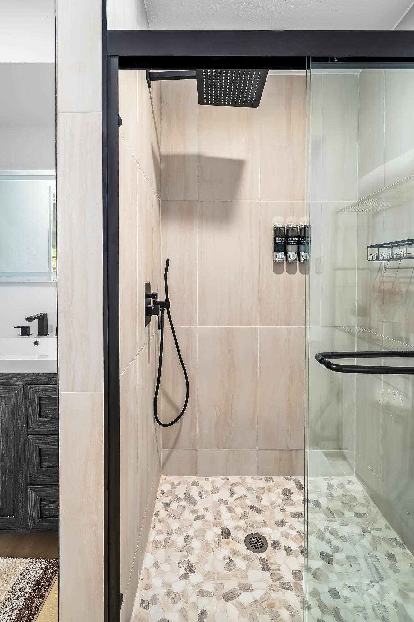 1250 SE 10TH Street, Deerfield Beach, Deerfield Beach, FL 33441 Enclosed shower with a glass door, matte black fixtures, rain showerhead, and pebble tile flooring