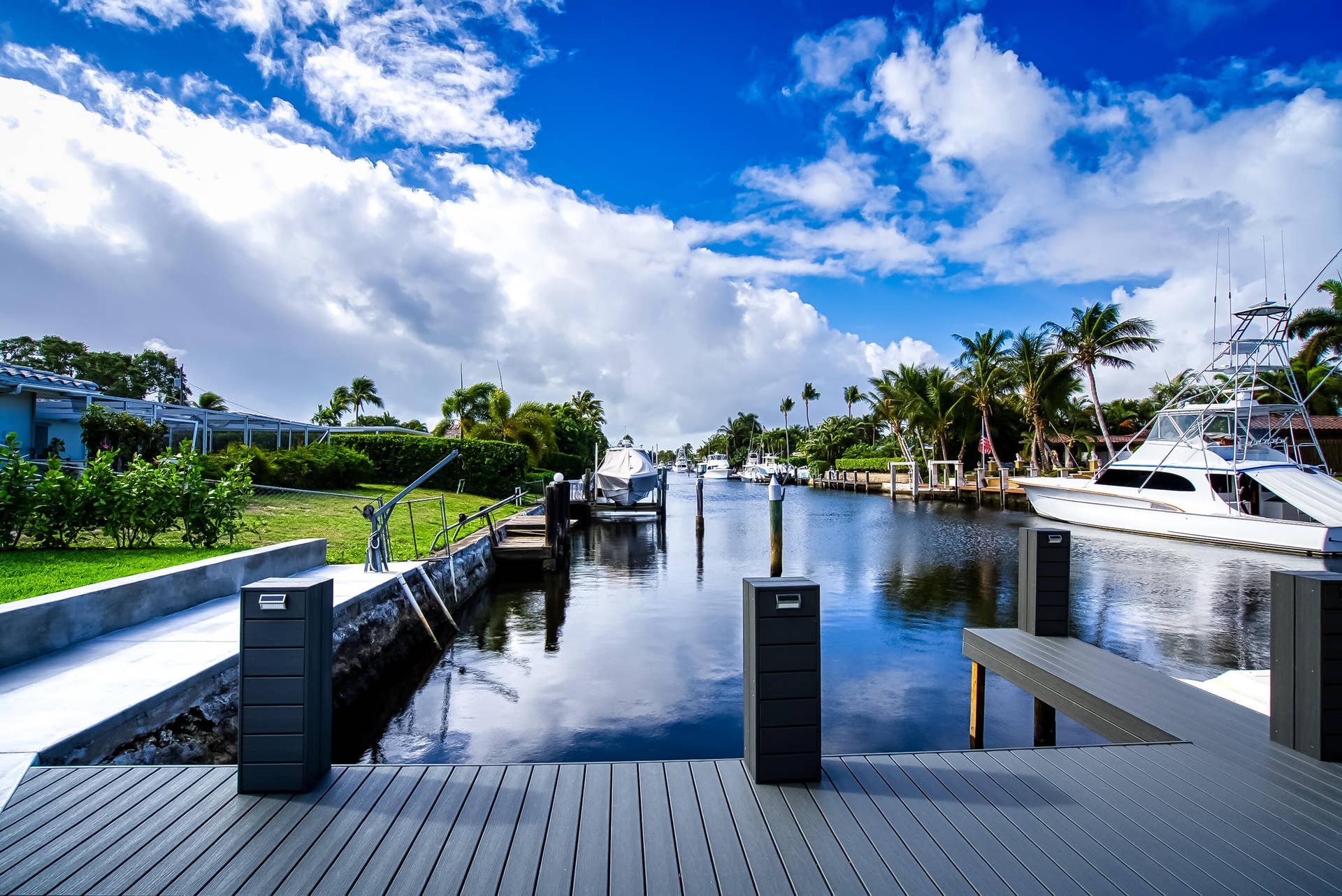1250 SE 10TH Street, Deerfield Beach, Deerfield Beach, FL 33441 Waterfront property featuring a composite deck, two docking pilings, and direct canal access