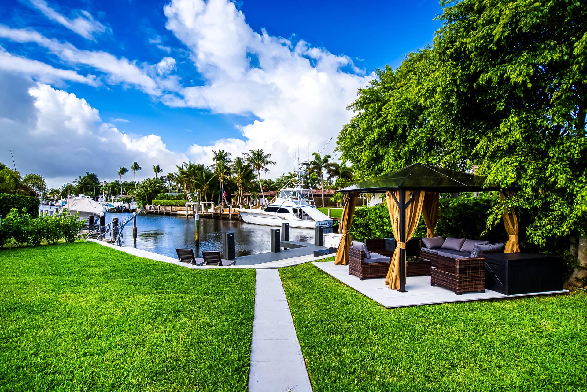 1250 SE 10TH Street, Deerfield Beach, Deerfield Beach, FL 33441 Manicured green lawn with a waterside dock featuring multiple boat slips