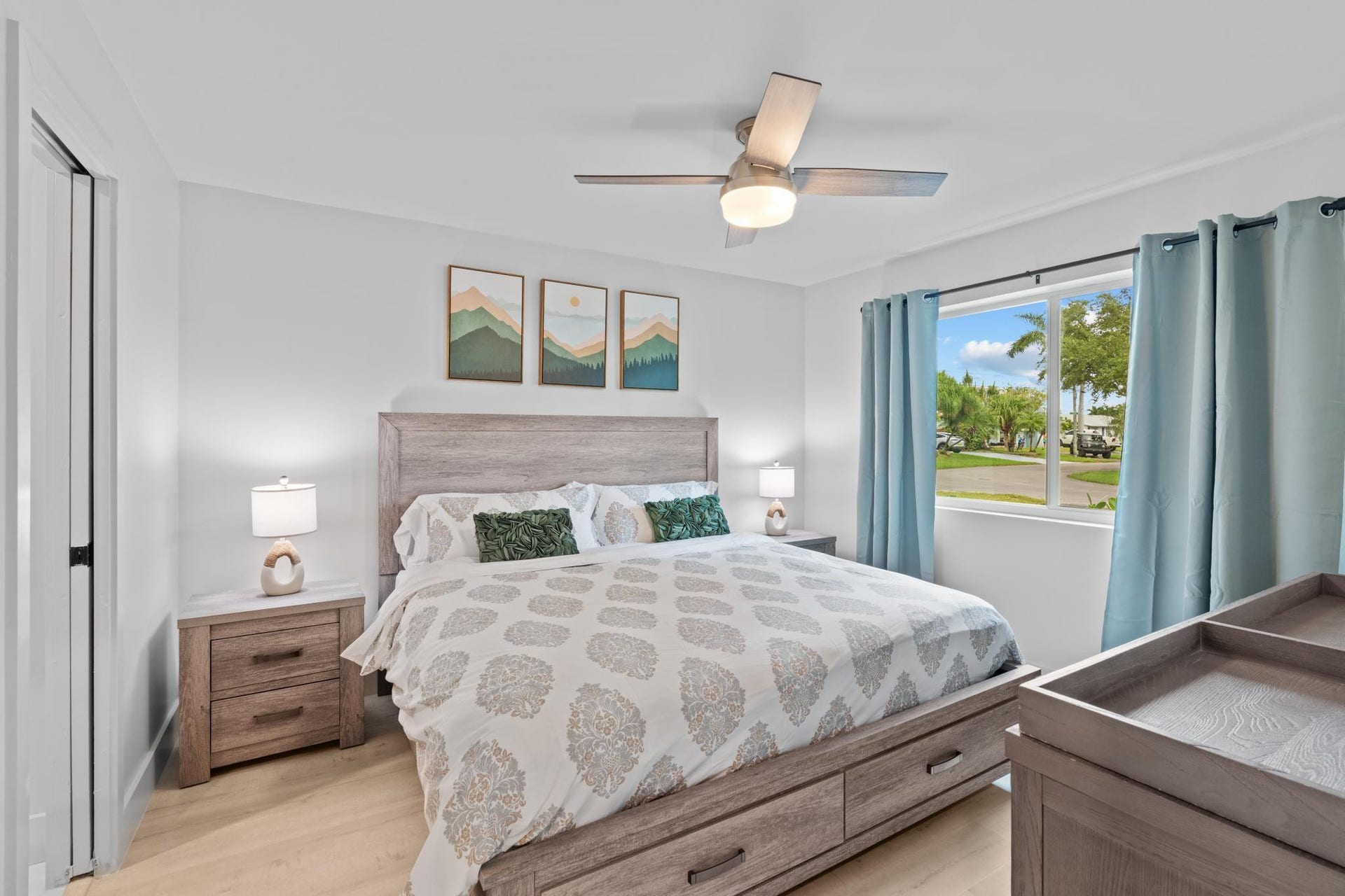 Light wood-finish flooring with a ceiling fan overhead