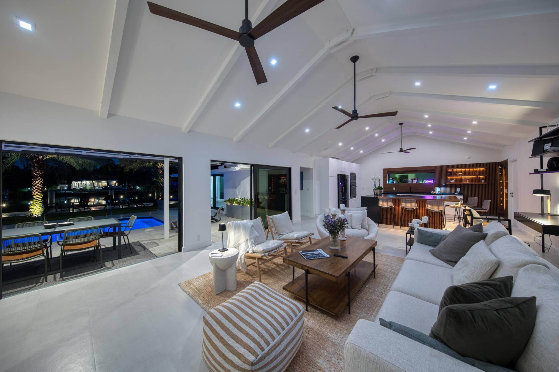 Gorgeous cathedral ceilings enhance the homes spaces and character looking out toward the pool