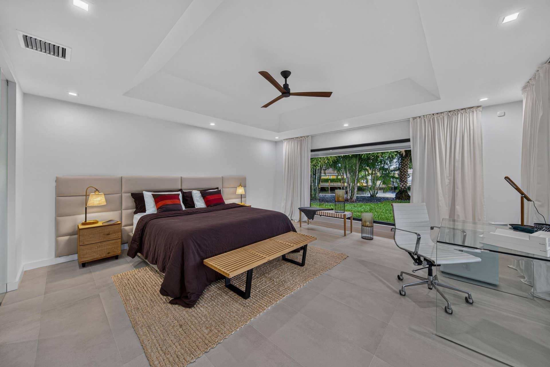 Oversized first primary bedroom with wide waterfront view