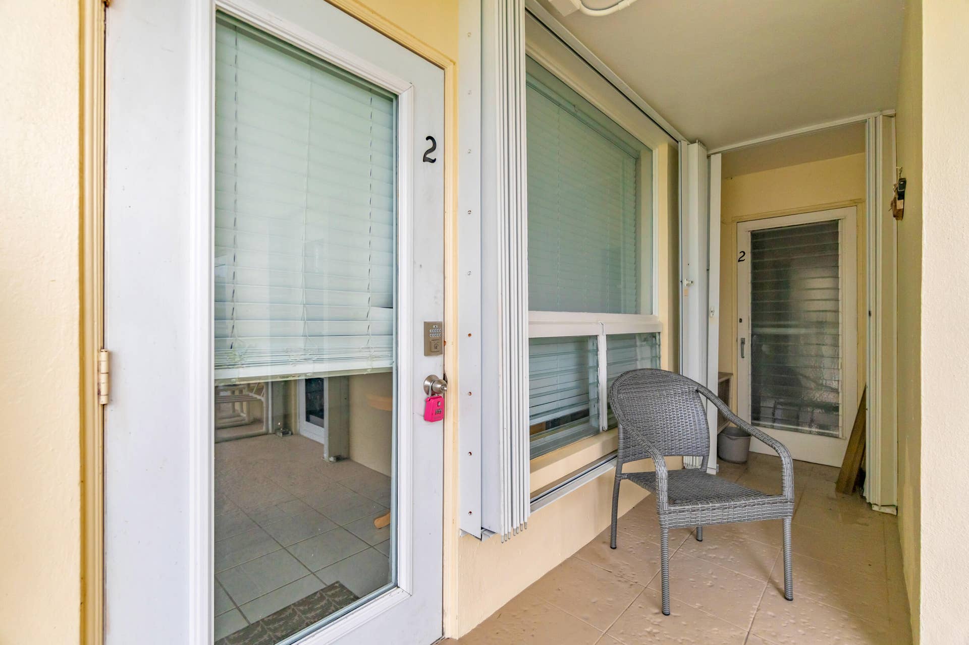 2840 NE 33RD Court, #2, Fort Lauderdale, FL 33306 Covered outdoor entry with a full-light entry door, fixed window, and tile flooring