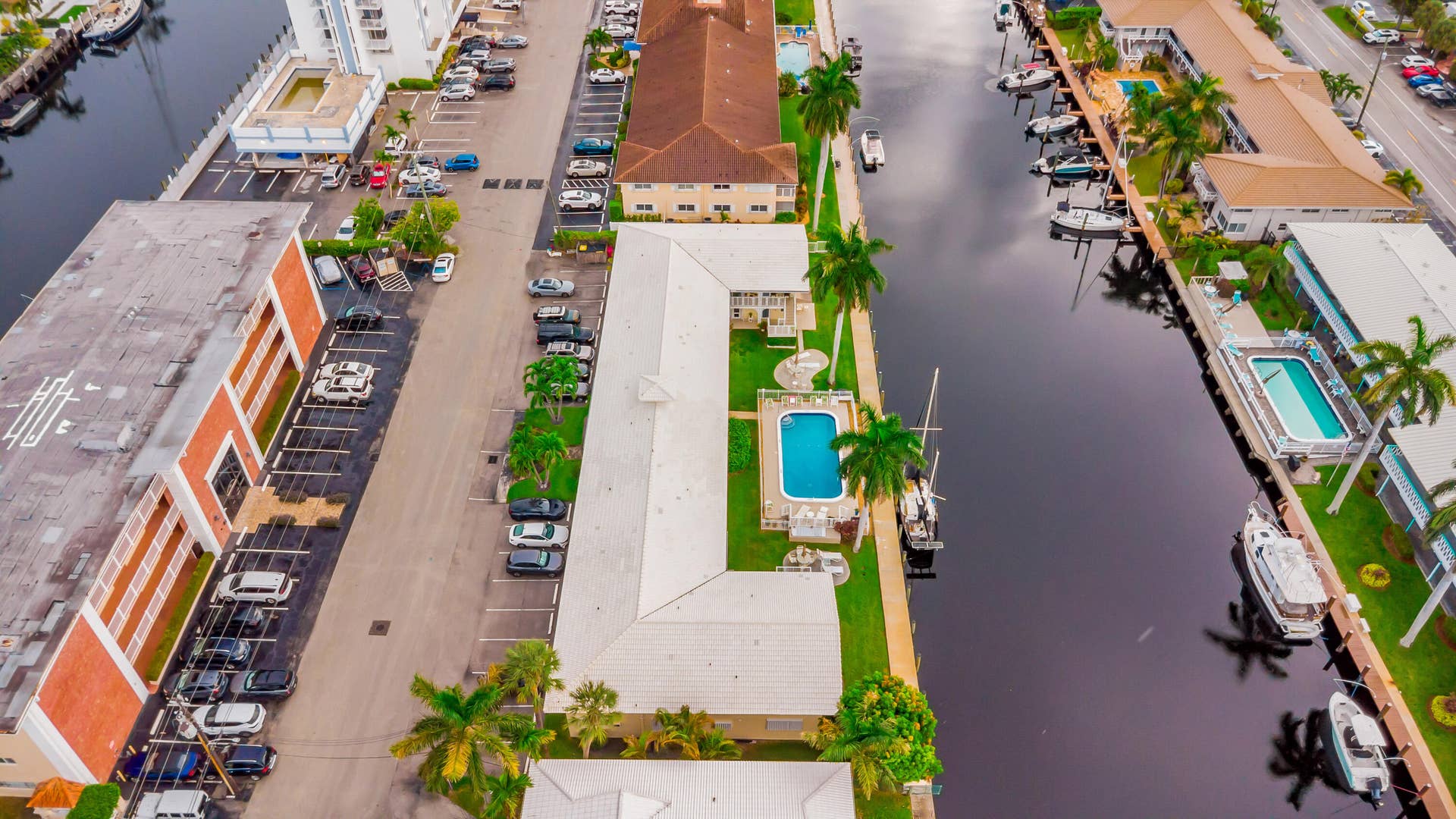 2840 NE 33RD Court, #2, Fort Lauderdale, FL 33306 Waterfront property featuring a private boat dock, outdoor swimming pool, and mature palm trees