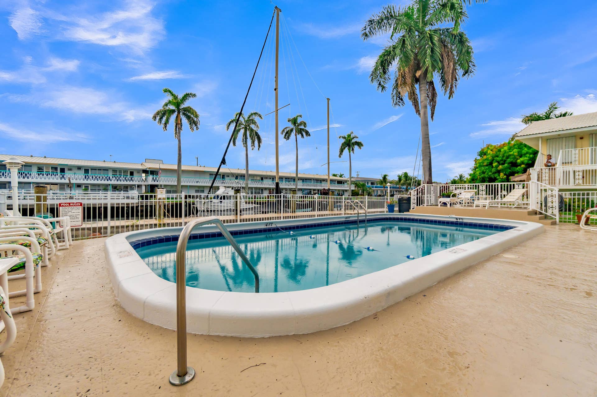 2840 NE 33RD Court, #2, Fort Lauderdale, FL 33306 Outdoor swimming pool with integrated steps and handrails, surrounded by a paved deck