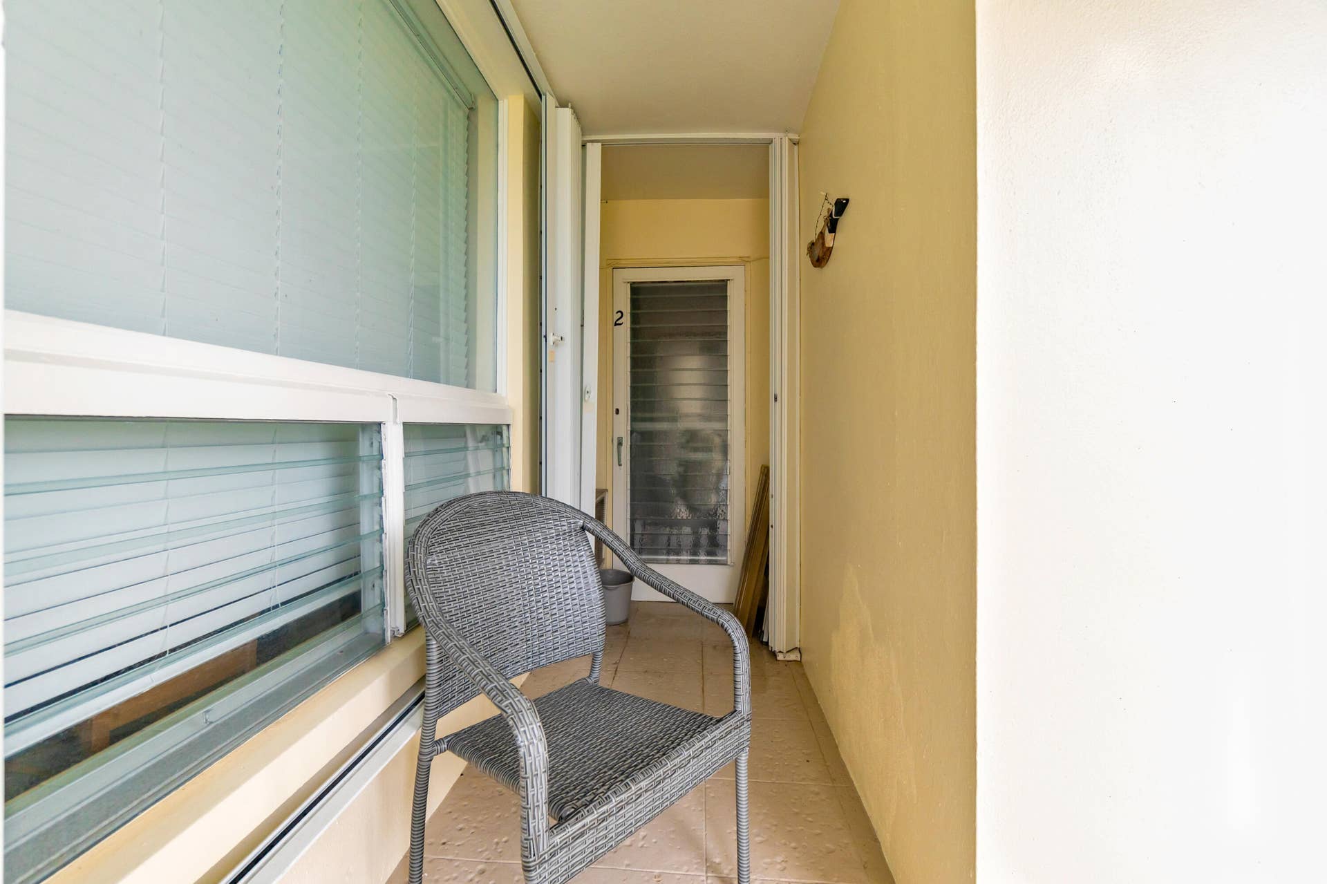 2840 NE 33RD Court, #2, Fort Lauderdale, FL 33306 Enclosed balcony featuring large windows with blinds and a textured floor