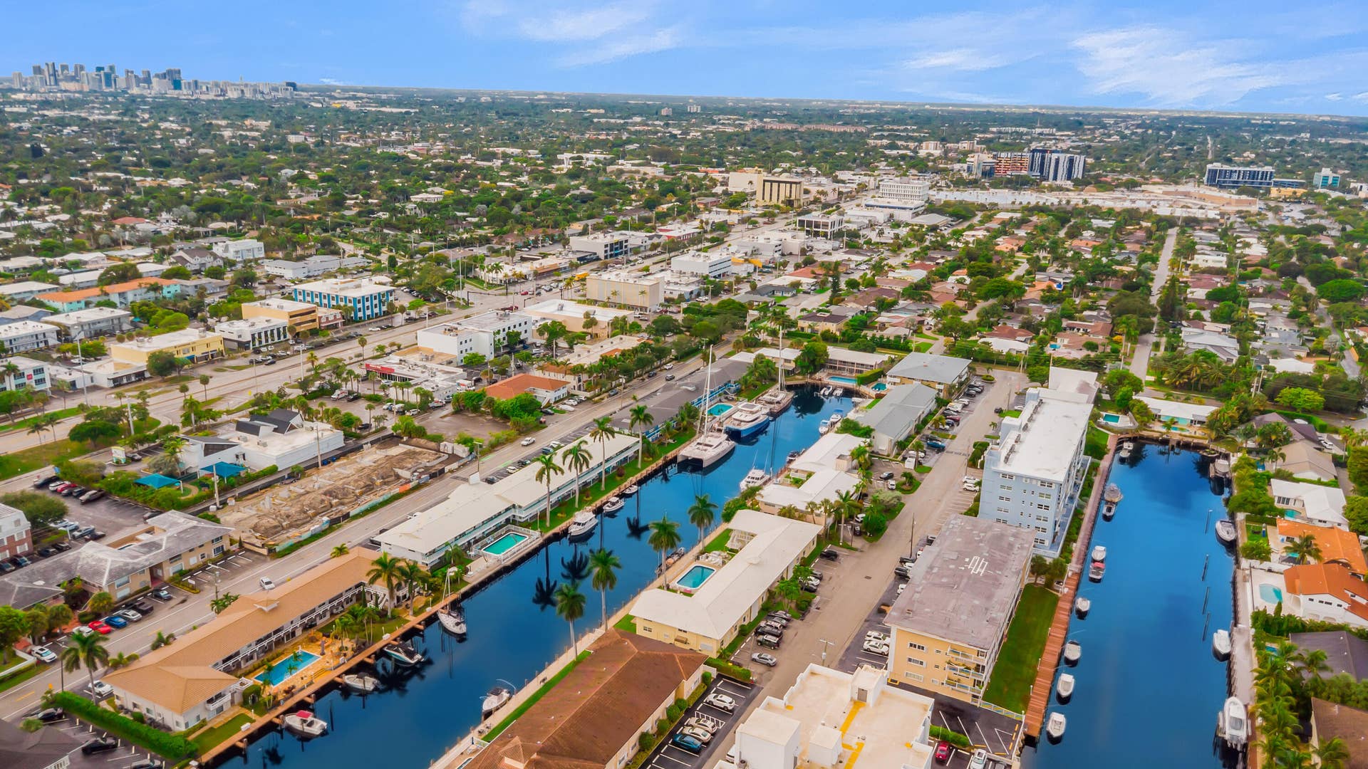 2840 NE 33RD Court, #2, Fort Lauderdale, FL 33306 Waterfront properties with direct canal access, established neighborhood with mature trees, and urban skyline in the distance