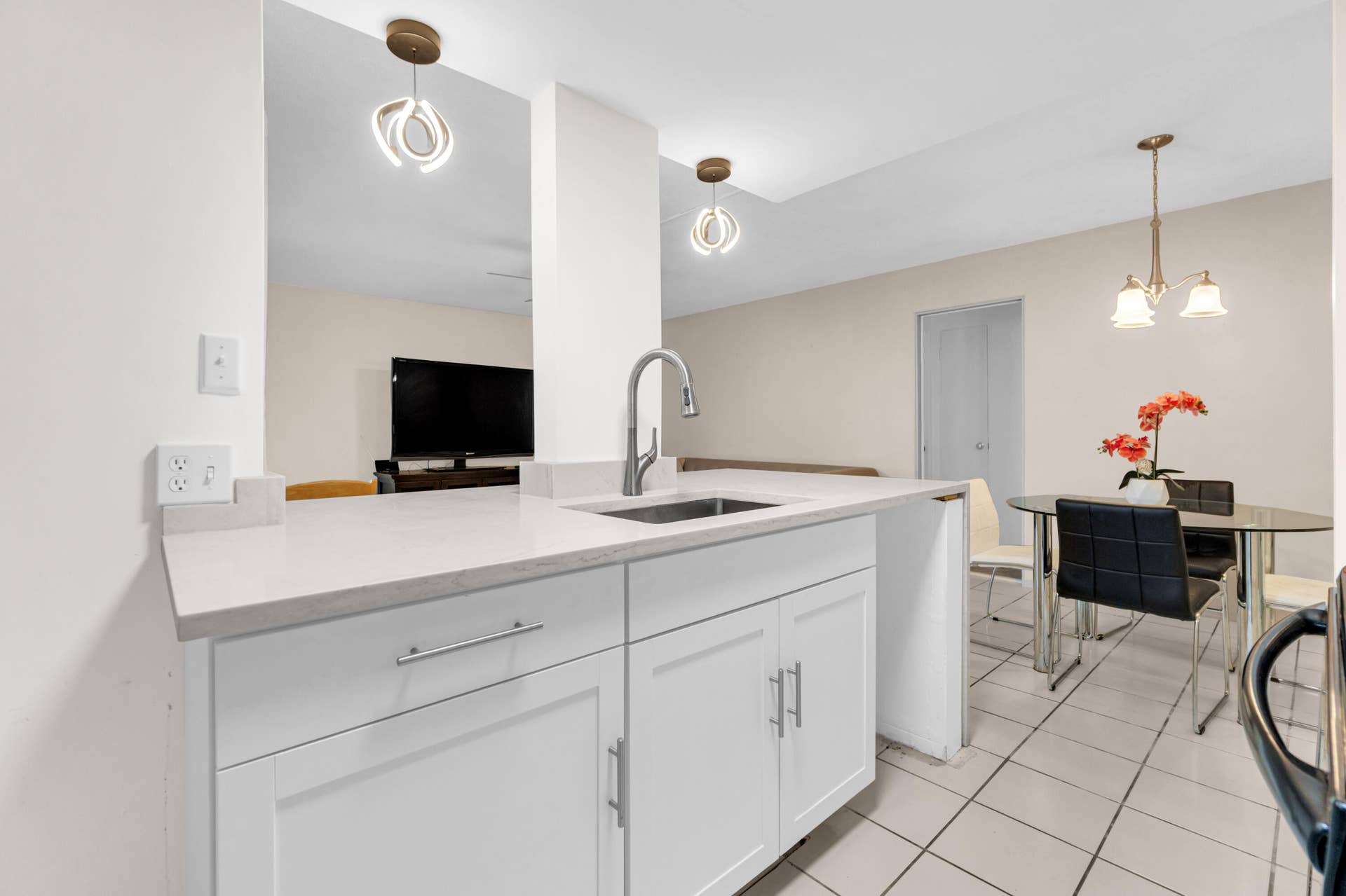 2840 NE 33RD Court, #2, Fort Lauderdale, FL 33306 White cabinetry with chrome hardware, an integrated sink, and light-toned countertop