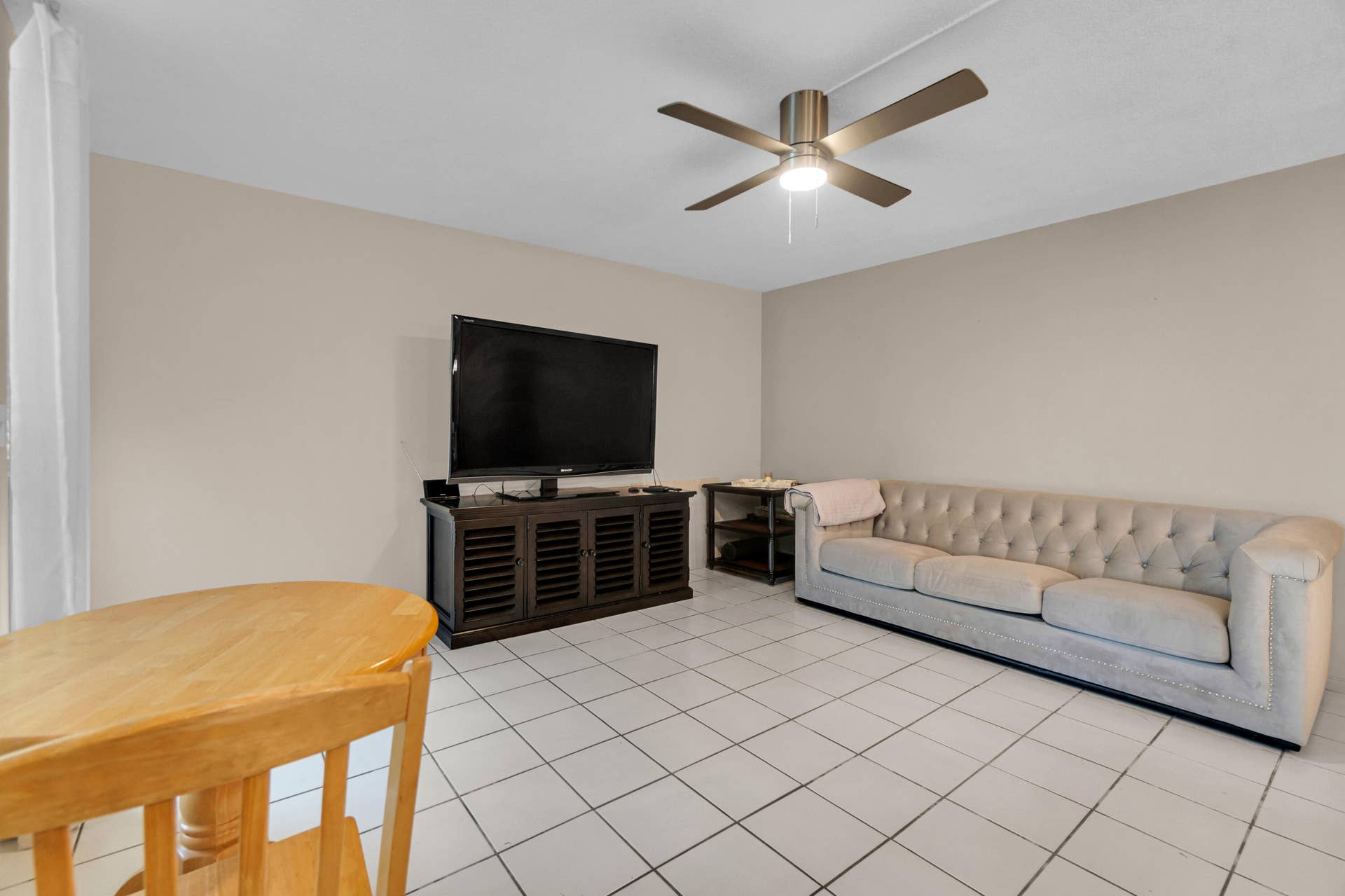 2840 NE 33RD Court, #2, Fort Lauderdale, FL 33306 Light-colored tile flooring, neutral wall paint, and a ceiling fan with integrated lighting