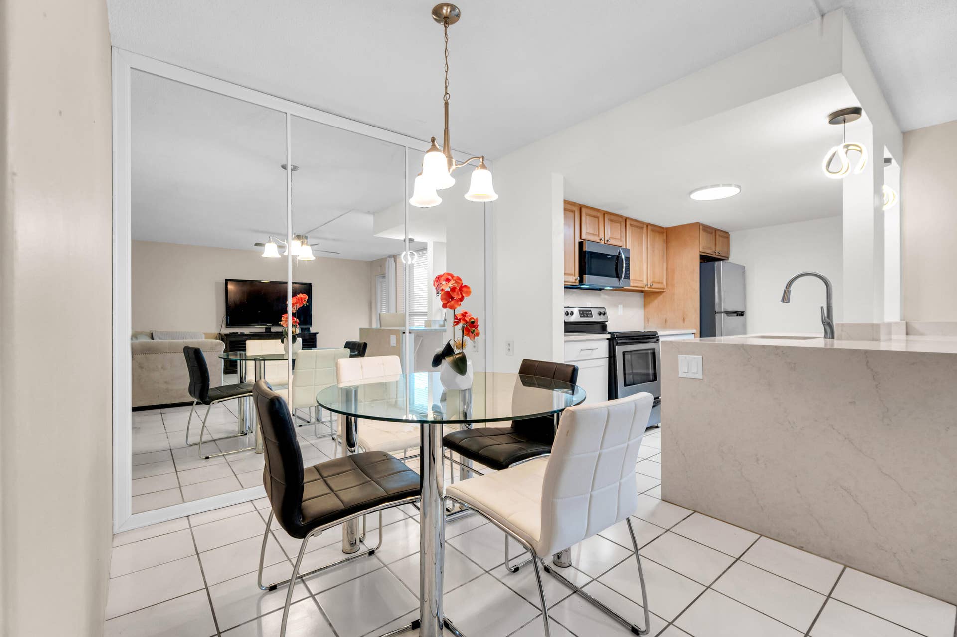 2840 NE 33RD Court, #2, Fort Lauderdale, FL 33306 Kitchen featuring wood cabinetry, stainless steel appliances, and a breakfast bar with stone-finish countertops