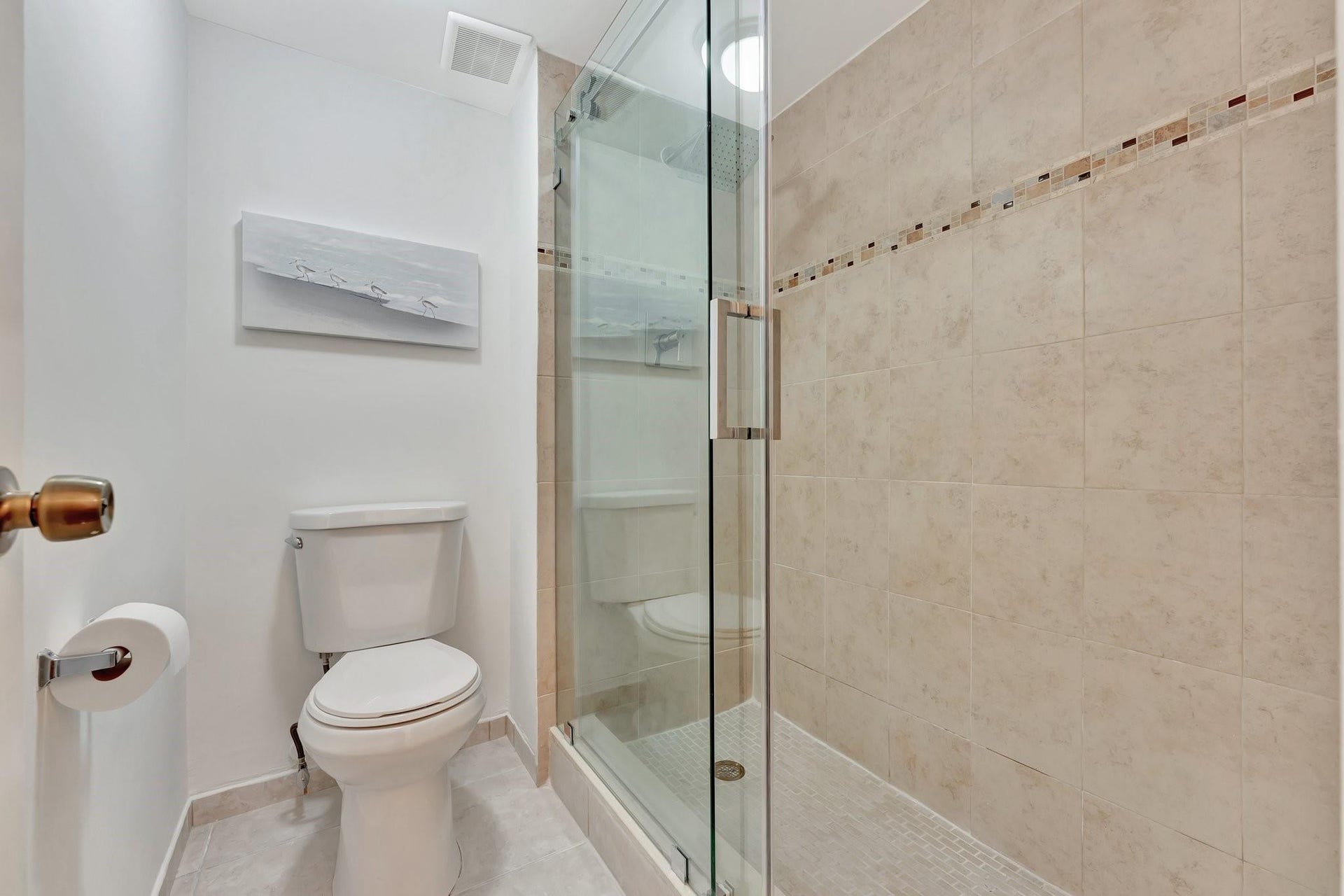 Separate private toilet and shower with seamless glass shower door