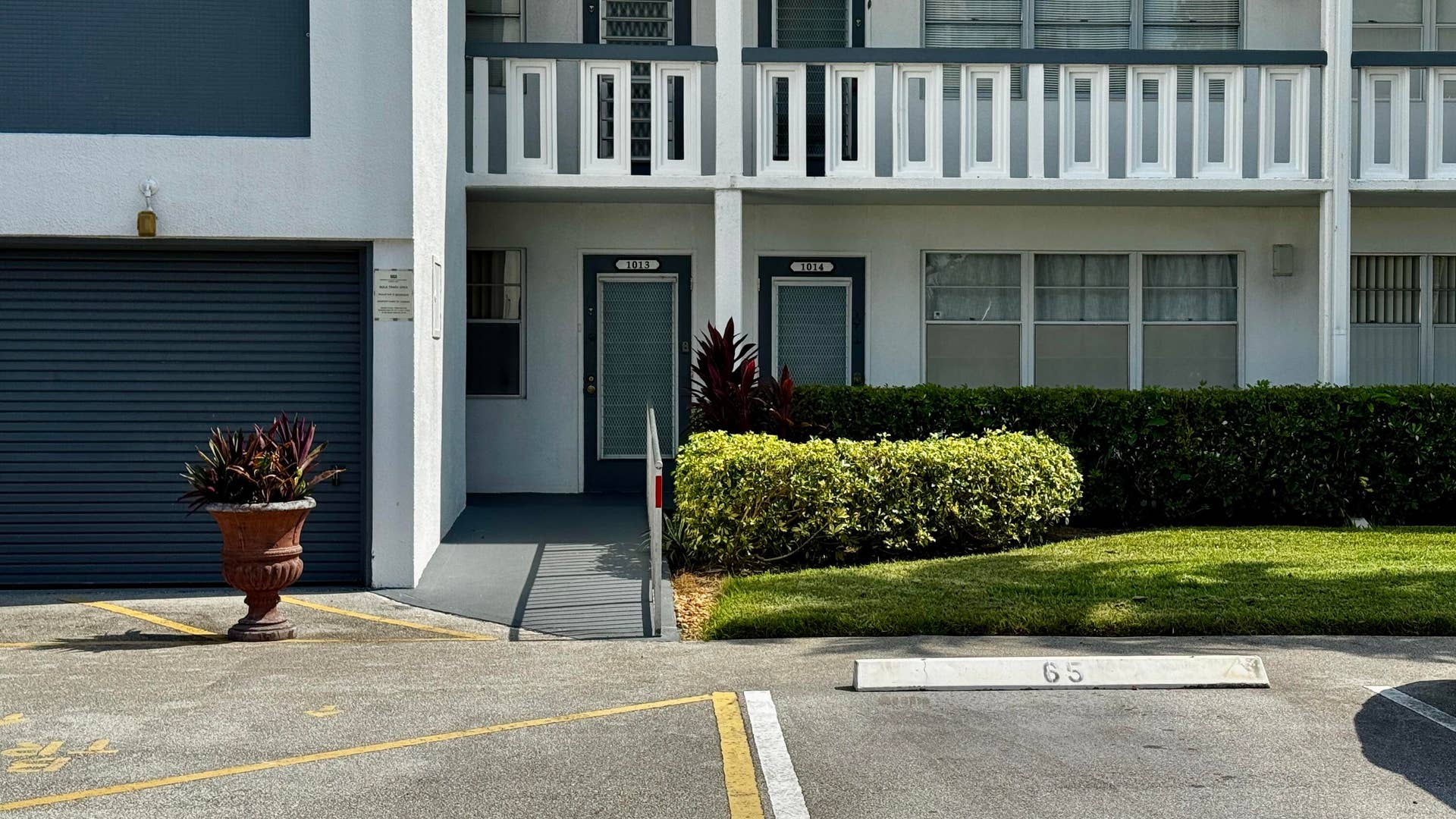 1013 HARWOOD C, #1013, Deerfield Beach, FL 33442 Ground-level unit with ramp access, private entry, and an attached garage with a roll-up door