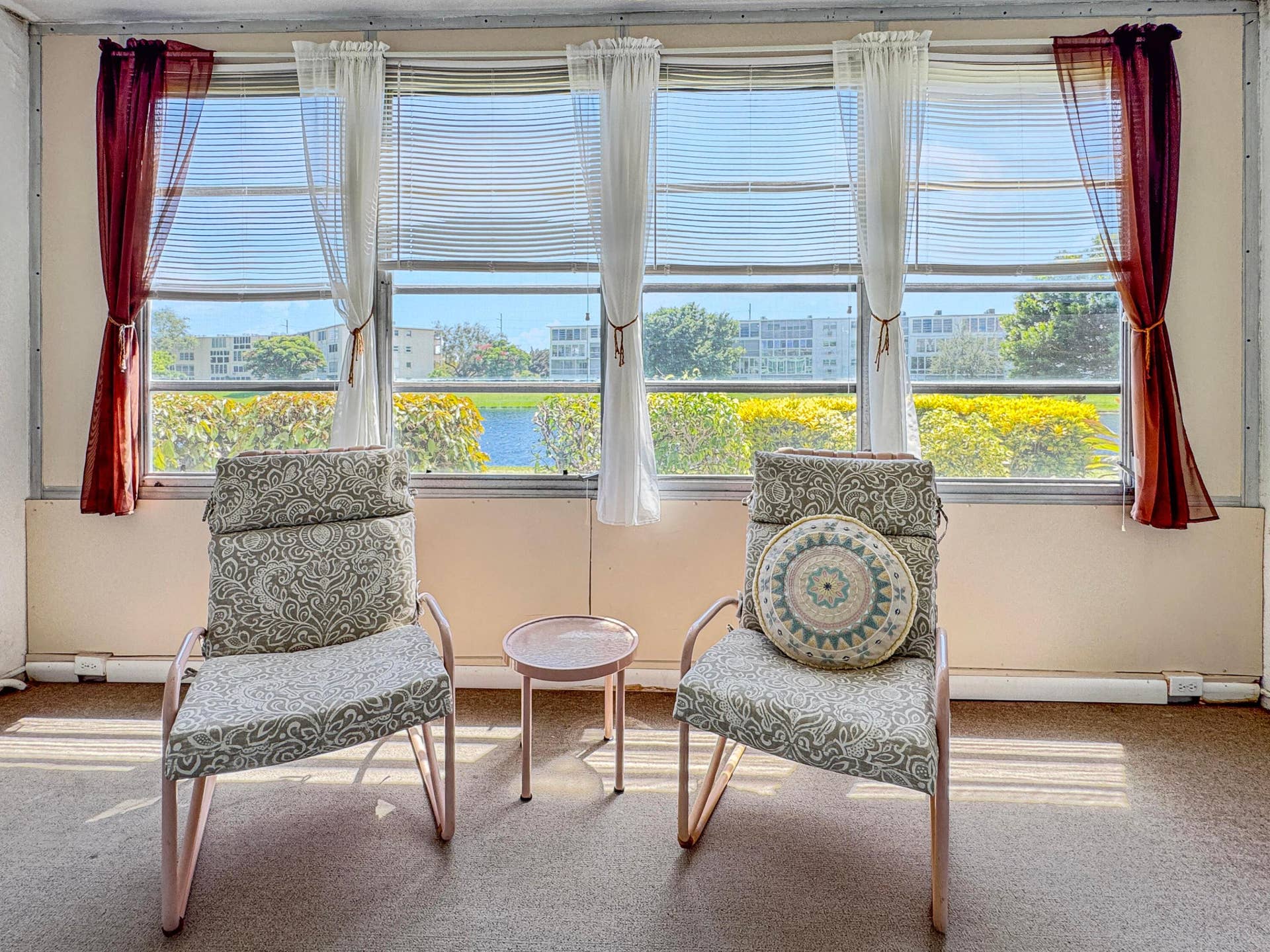 1013 HARWOOD C, #1013, Deerfield Beach, FL 33442 Sunlit room featuring multiple windows with horizontal blinds, providing natural illumination