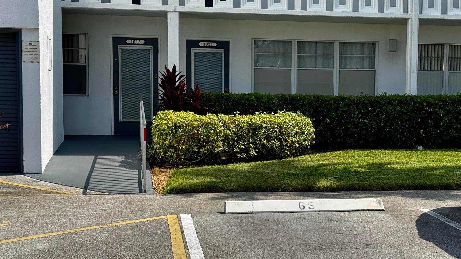 1013 HARWOOD C, #1013, Deerfield Beach, FL 33442 Ground-level unit with ramp access, patterned facade, and a neatly manicured lawn