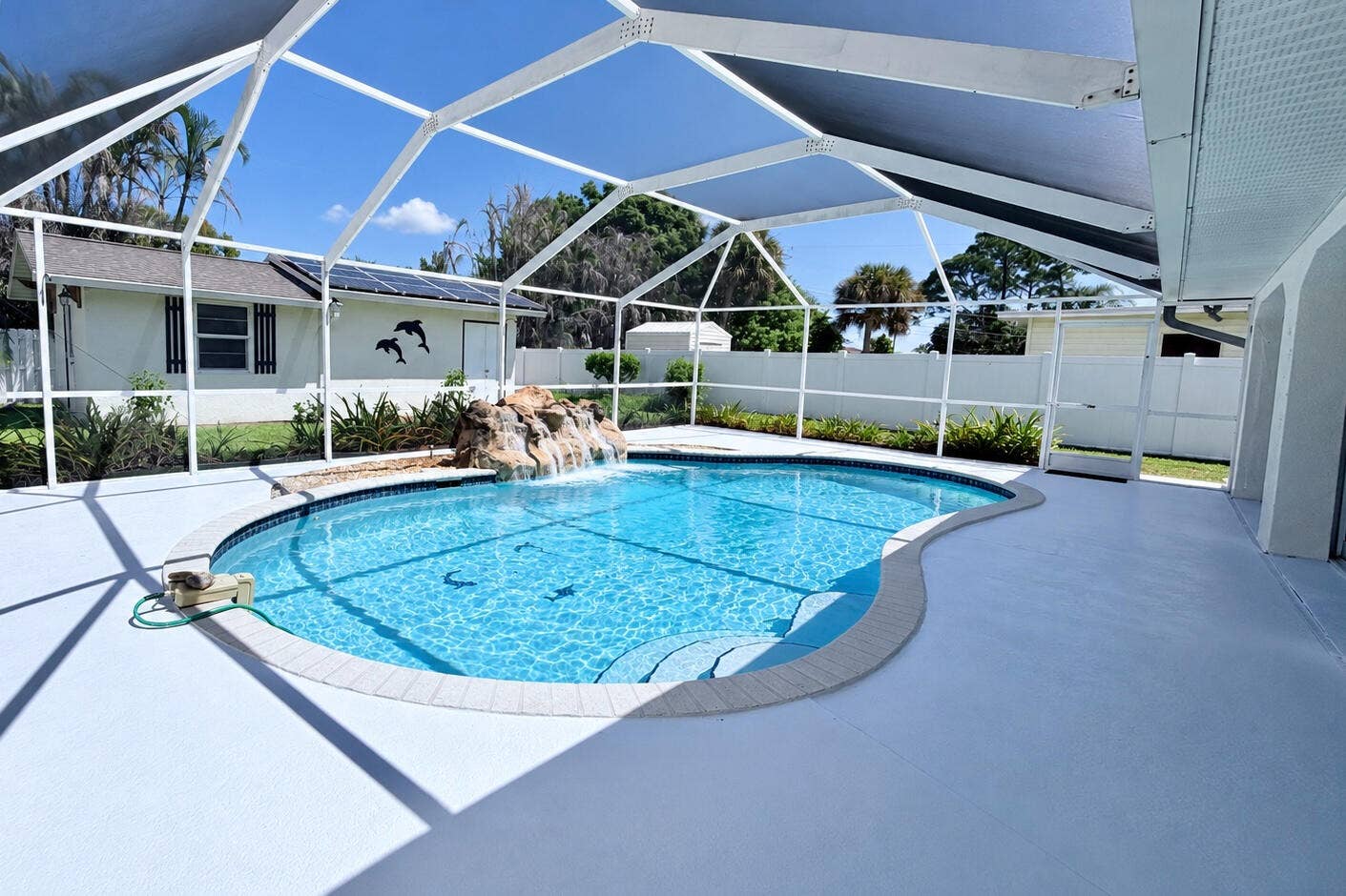 Saline System Heated Screened In Pool with Waterfall Accent