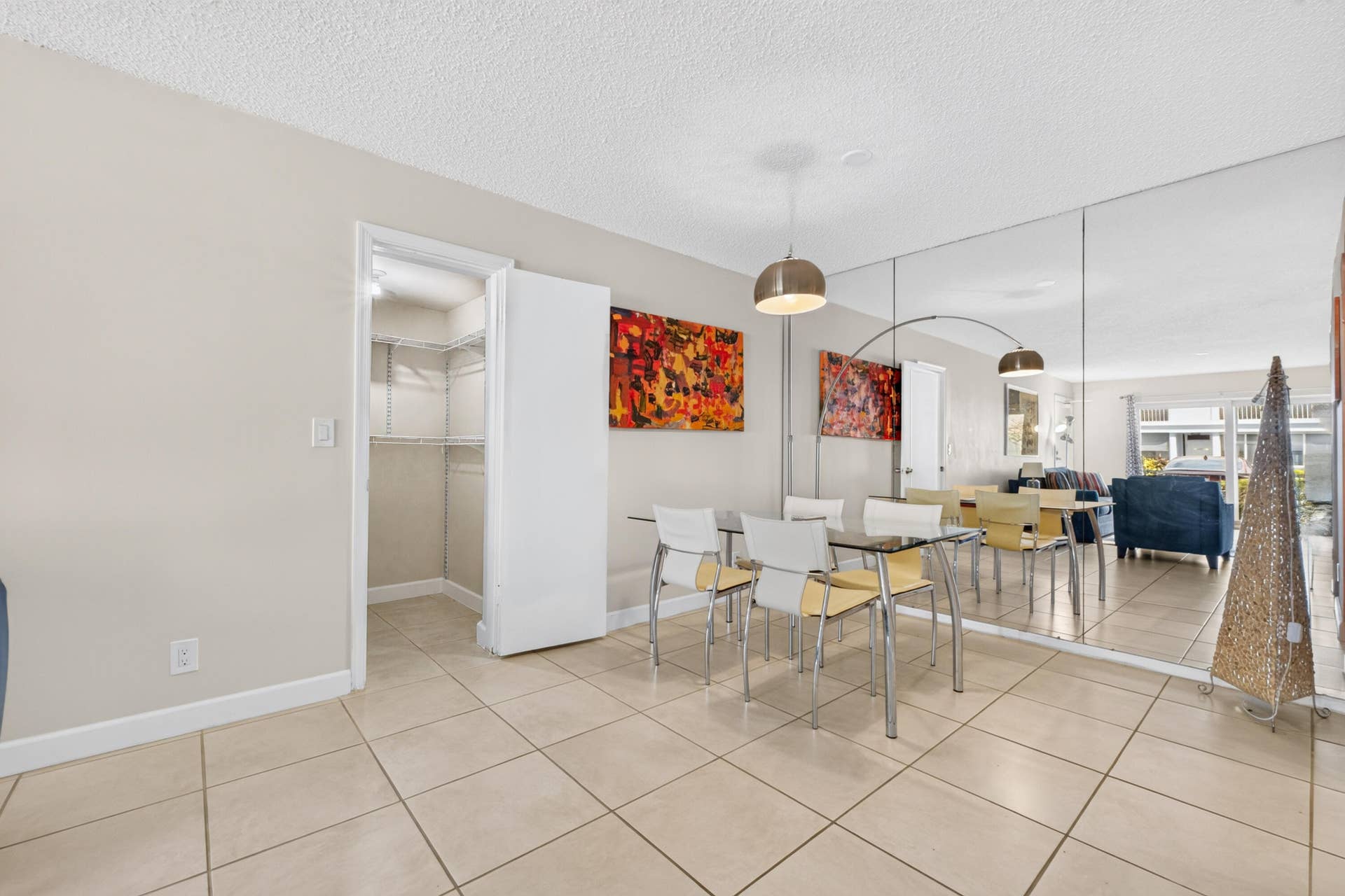 6359 Bay Club Drive, #2, Fort Lauderdale, FL 33308 Tile flooring throughout, full-wall mirror, pendant lighting, and a built-in closet system