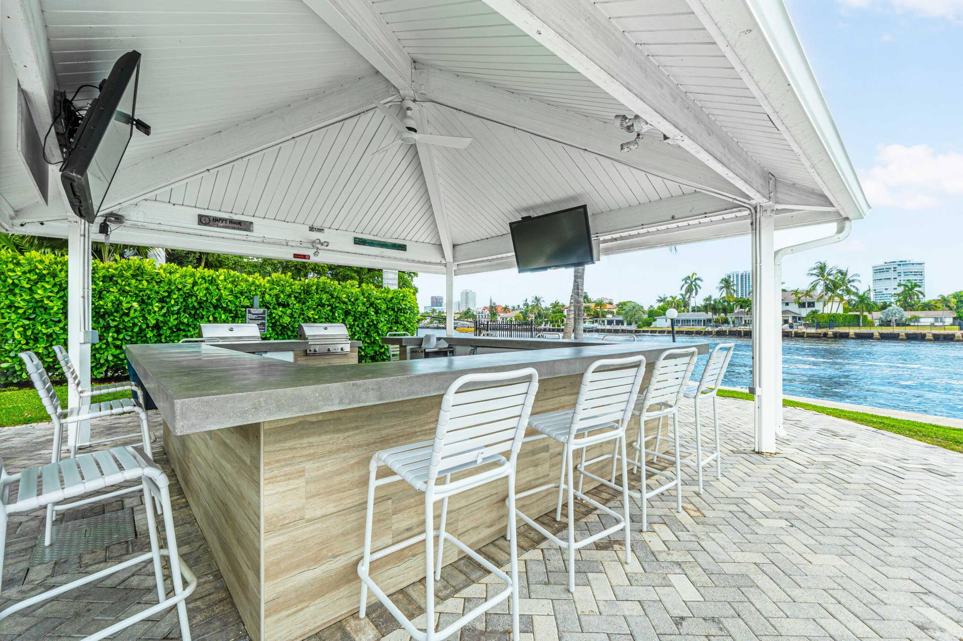 6359 Bay Club Drive, #2, Fort Lauderdale, FL 33308 Waterfront outdoor entertaining area with a covered bar, built-in grills, and paver patio