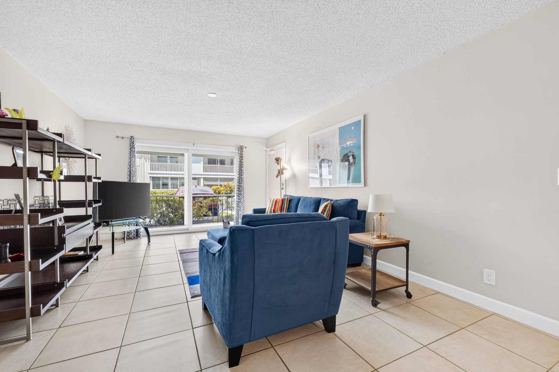 6359 Bay Club Drive, #2, Fort Lauderdale, FL 33308 Ceramic tile flooring, white walls, and a sliding glass door providing balcony access