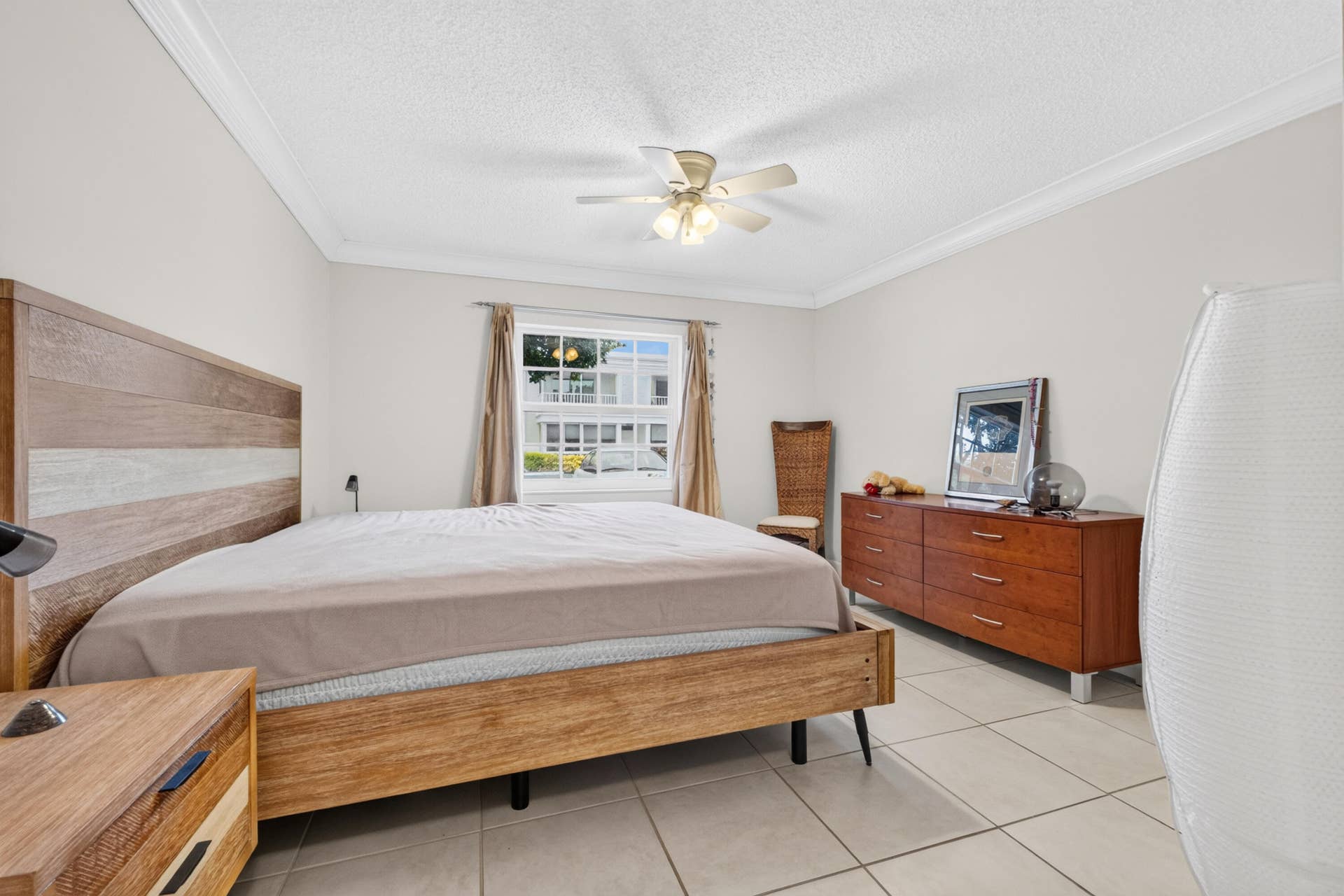 6359 Bay Club Drive, #2, Fort Lauderdale, FL 33308 Crown molding, ceiling fan, window with horizontal muntins, and tiled flooring