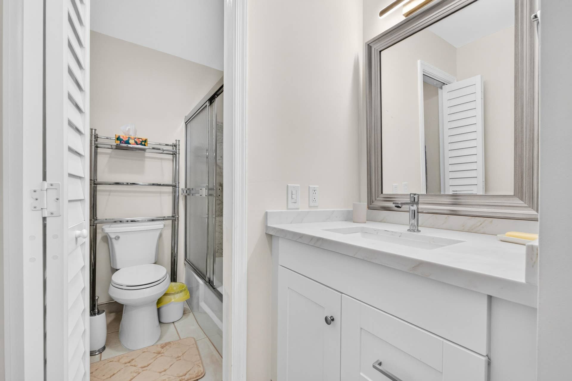 6359 Bay Club Drive, #2, Fort Lauderdale, FL 33308 White shaker vanity with chrome hardware, an undermount sink, and a light-toned countertop