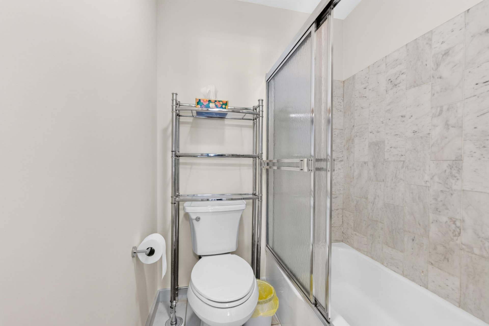 6359 Bay Club Drive, #2, Fort Lauderdale, FL 33308 White tiled shower surround with a sliding glass door and a white bathtub