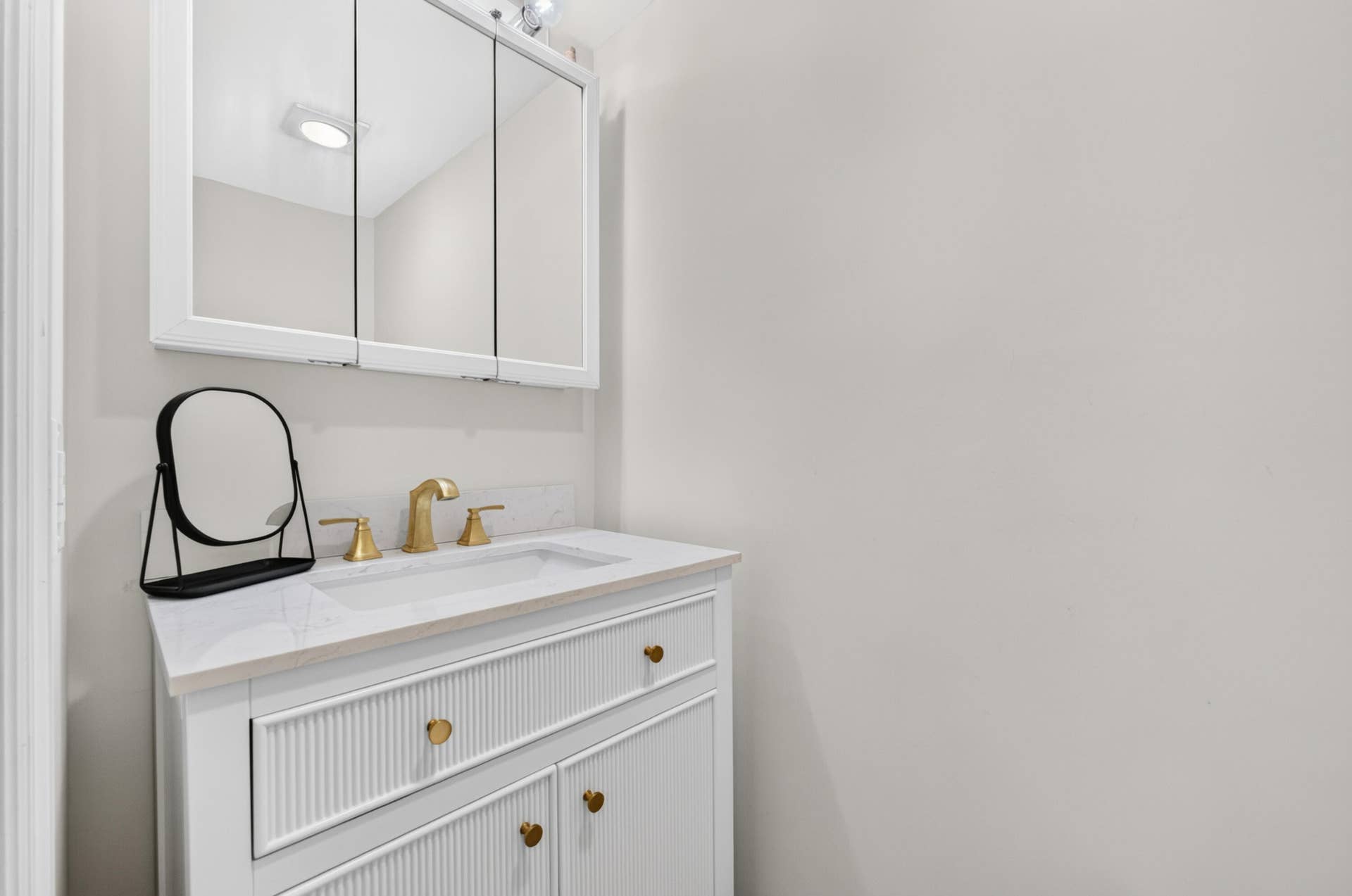 6359 Bay Club Drive, #2, Fort Lauderdale, FL 33308 White vanity with gold-tone hardware, undermount sink, and polished countertop