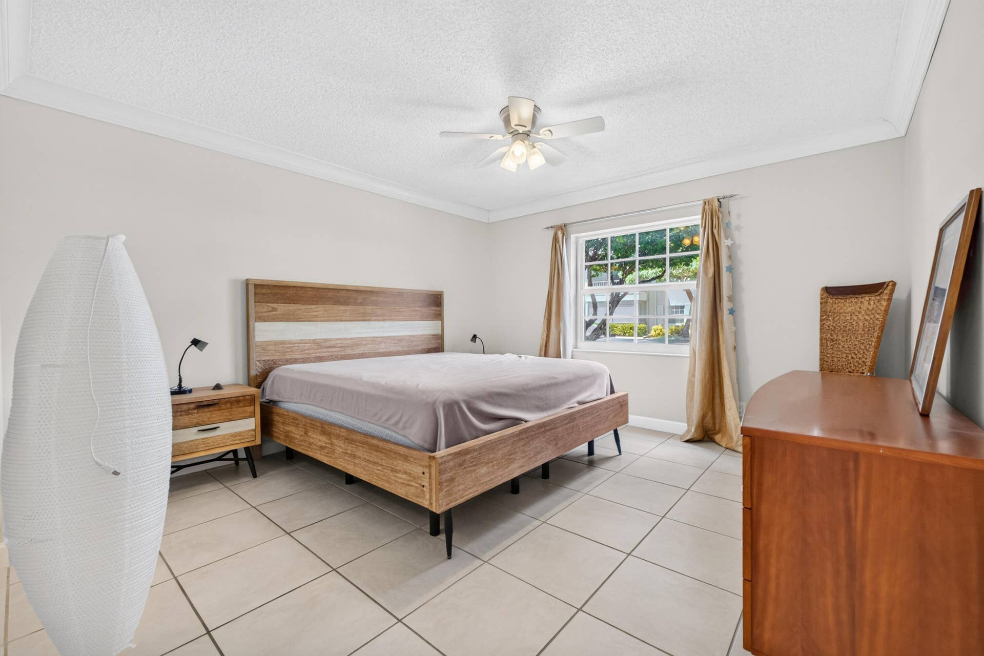 6359 Bay Club Drive, #2, Fort Lauderdale, FL 33308 Crown molding, tiled flooring, ceiling fan, and window with outdoor greenery