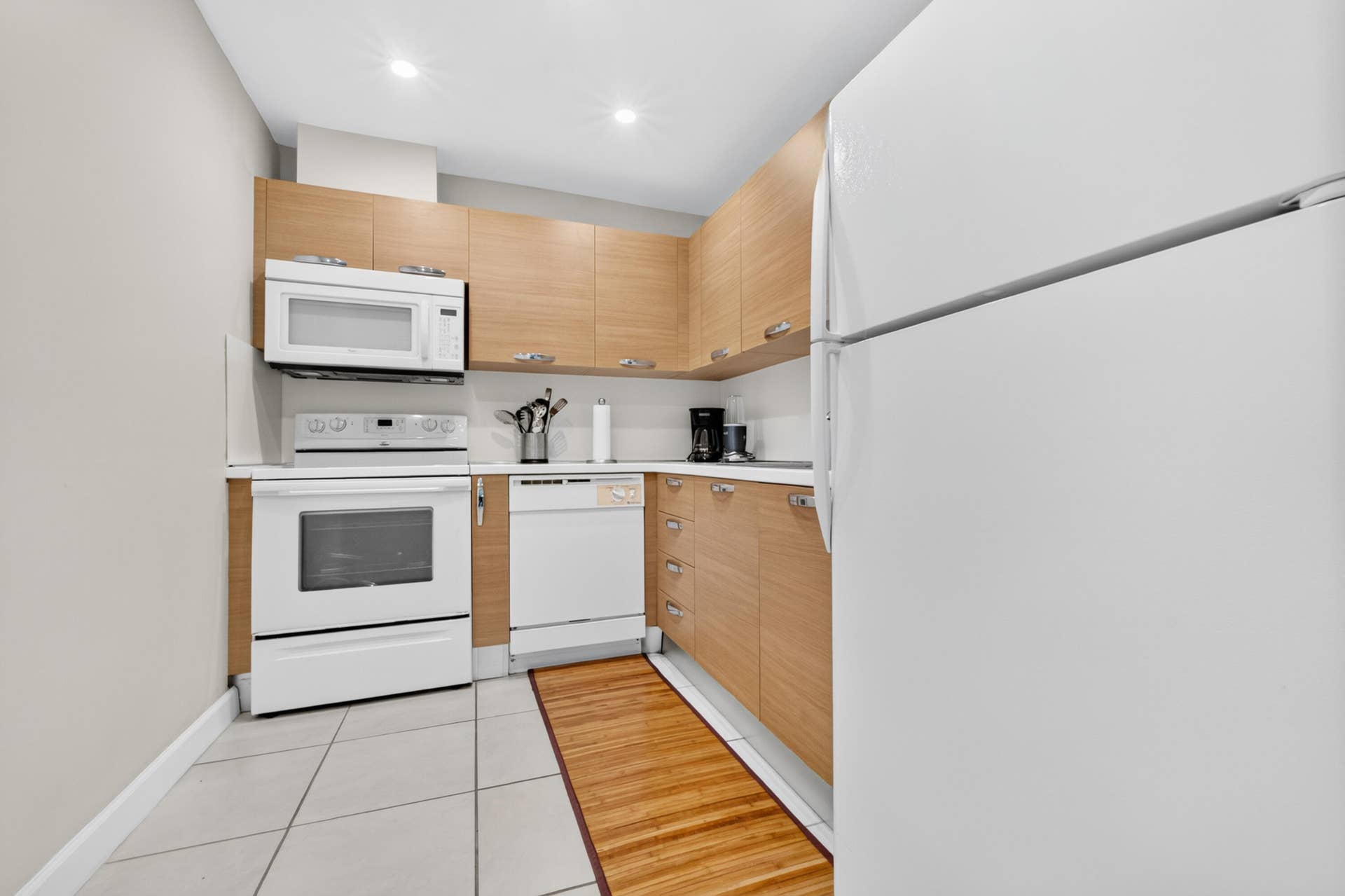 6359 Bay Club Drive, #2, Fort Lauderdale, FL 33308 Kitchen featuring wood-finish cabinetry, white appliances, built-in microwave, white countertops, and recessed lighting