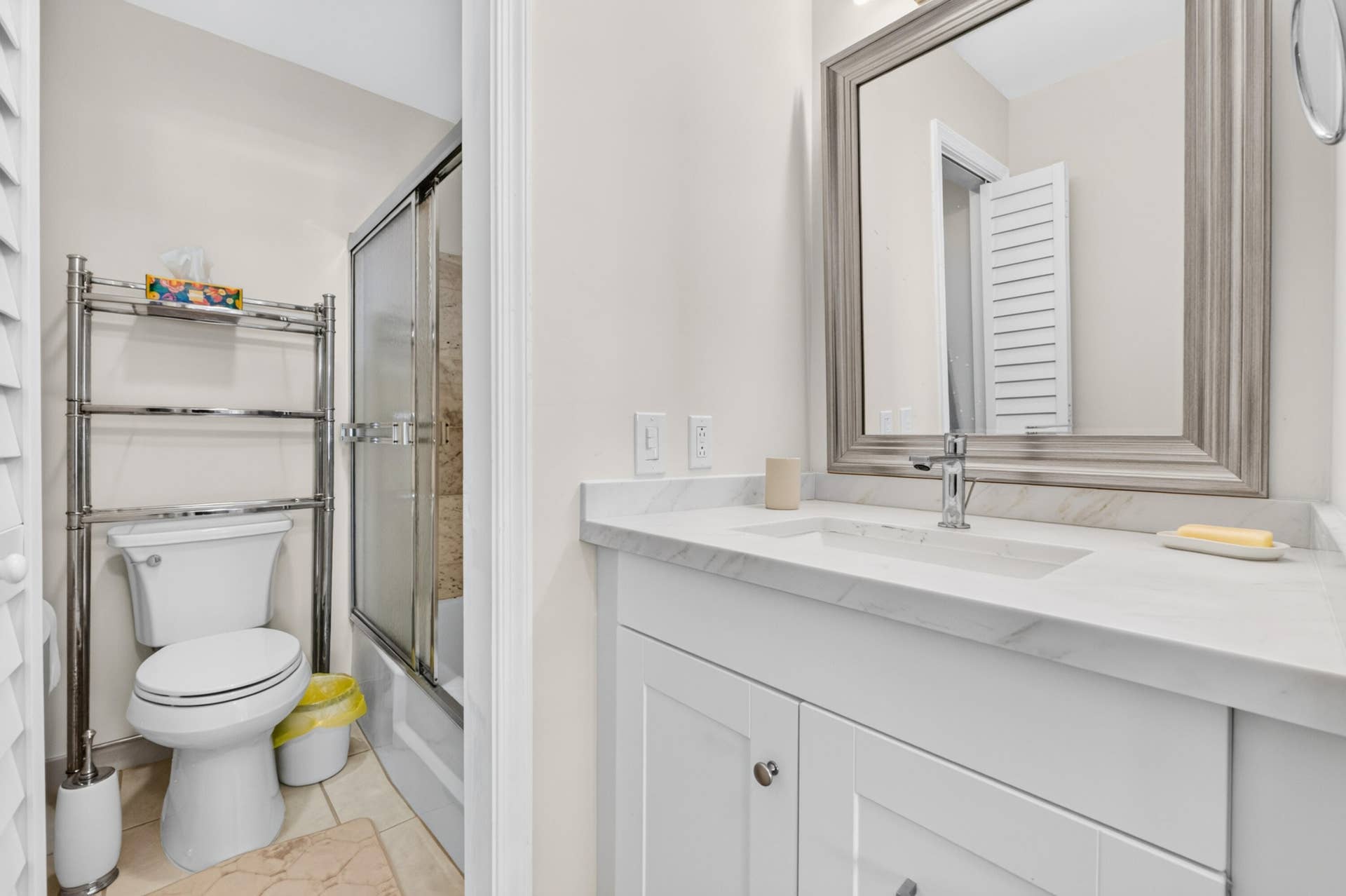 6359 Bay Club Drive, #2, Fort Lauderdale, FL 33308 White vanity with a light-colored countertop, framed mirror, and a chrome faucet