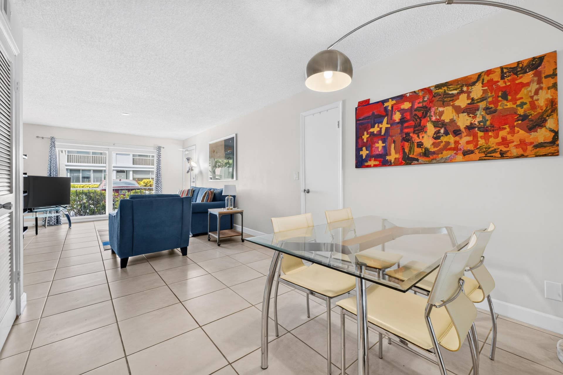 6359 Bay Club Drive, #2, Fort Lauderdale, FL 33308 Open concept living and dining area with tile flooring throughout, white walls, and a sliding glass door