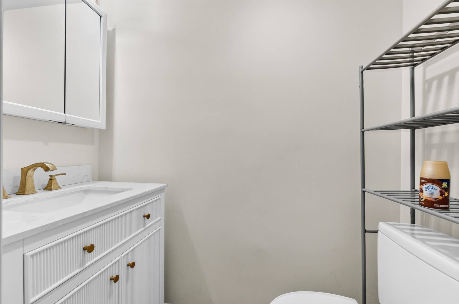 6359 Bay Club Drive, #2, Fort Lauderdale, FL 33308 Spa-inspired bathroom featuring a white vanity with ribbed cabinetry, white quartz countertop, and brass-finish faucet