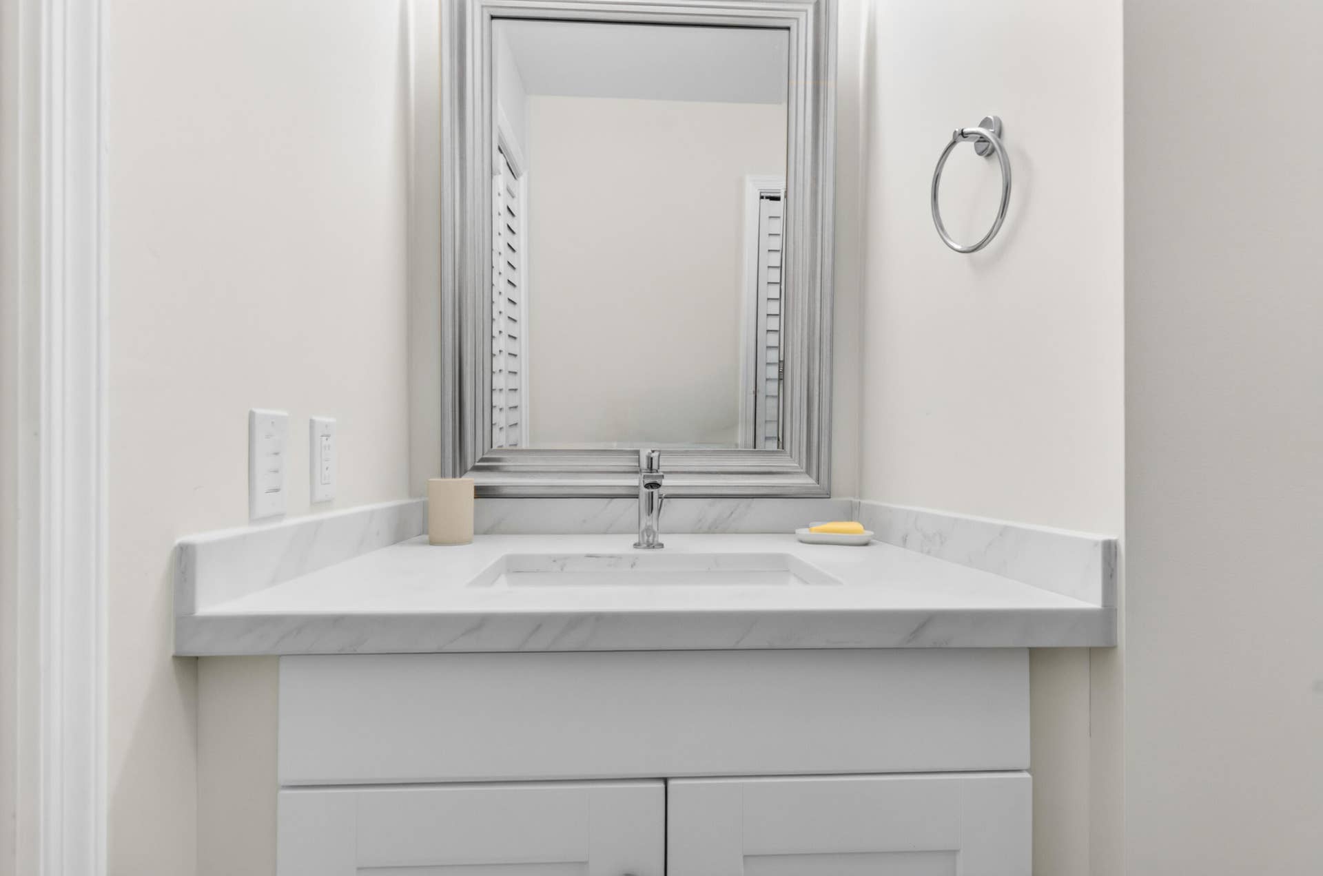 6359 Bay Club Drive, #2, Fort Lauderdale, FL 33308 White vanity with a polished chrome faucet, under-mount sink, and a framed mirror