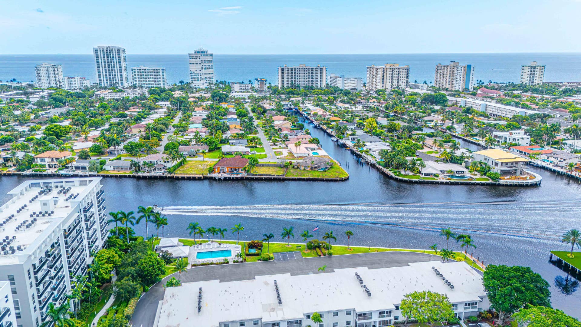 6359 Bay Club Drive, #2, Fort Lauderdale, FL 33308 Waterfront living with direct intracoastal access, resort-style heated pool with surrounding hardscape and mature landscaping, expansive water views, and proximity to high-rise amenities and downtown skyline in an established residential community