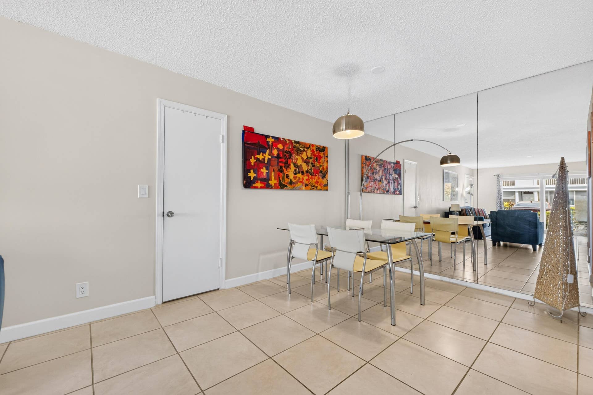 6359 Bay Club Drive, #2, Fort Lauderdale, FL 33308 Open dining area with neutral tile flooring, contemporary pendant lighting, and large mirror wall accents