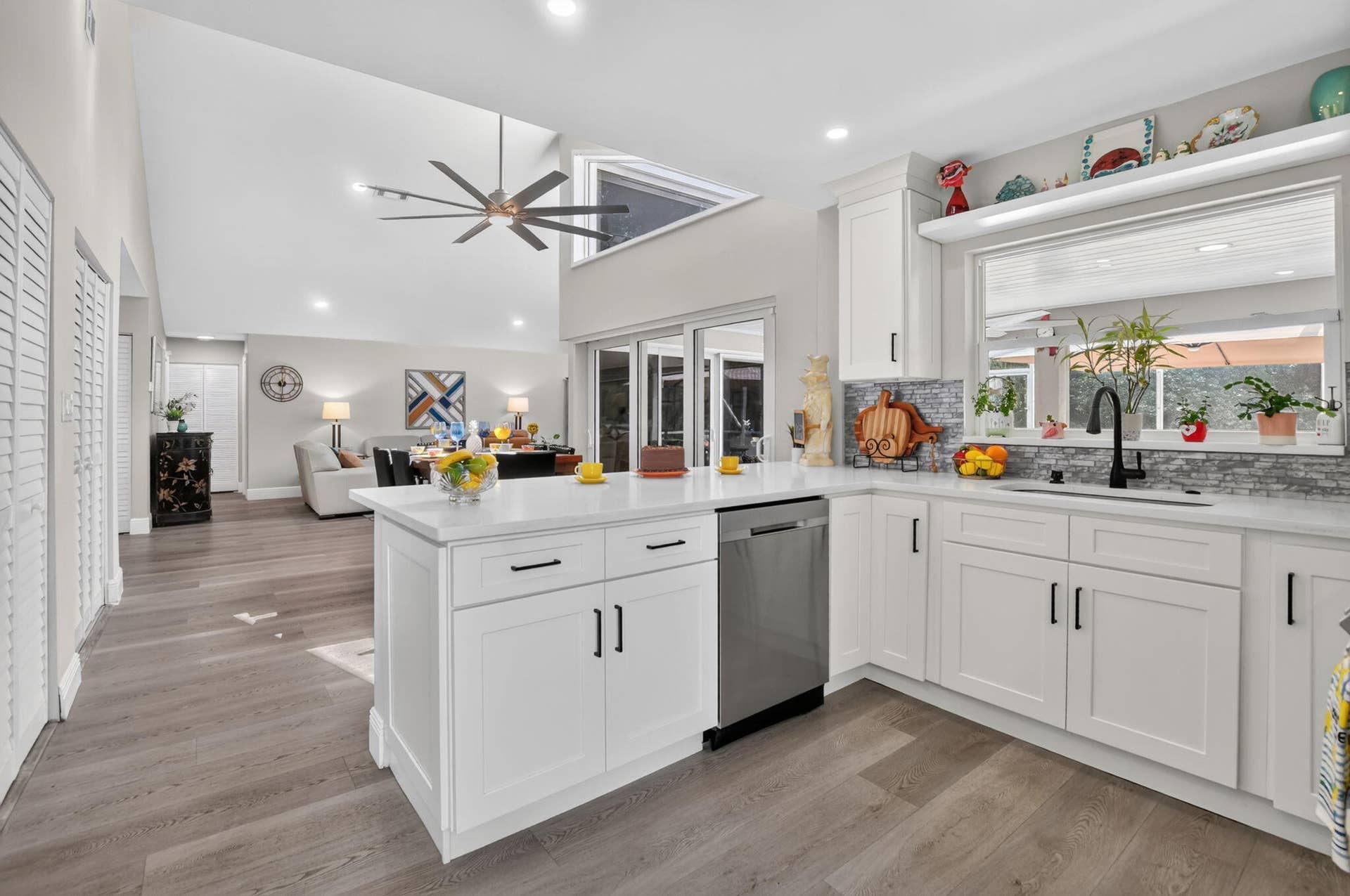 2738 DEER CREEK KELLY BROOKE Lane, Deerfield Beach, FL 33442 Gorgeous kitchen highlights a deep farmhouse sink, full glass backsplash with pass thru window to patio.