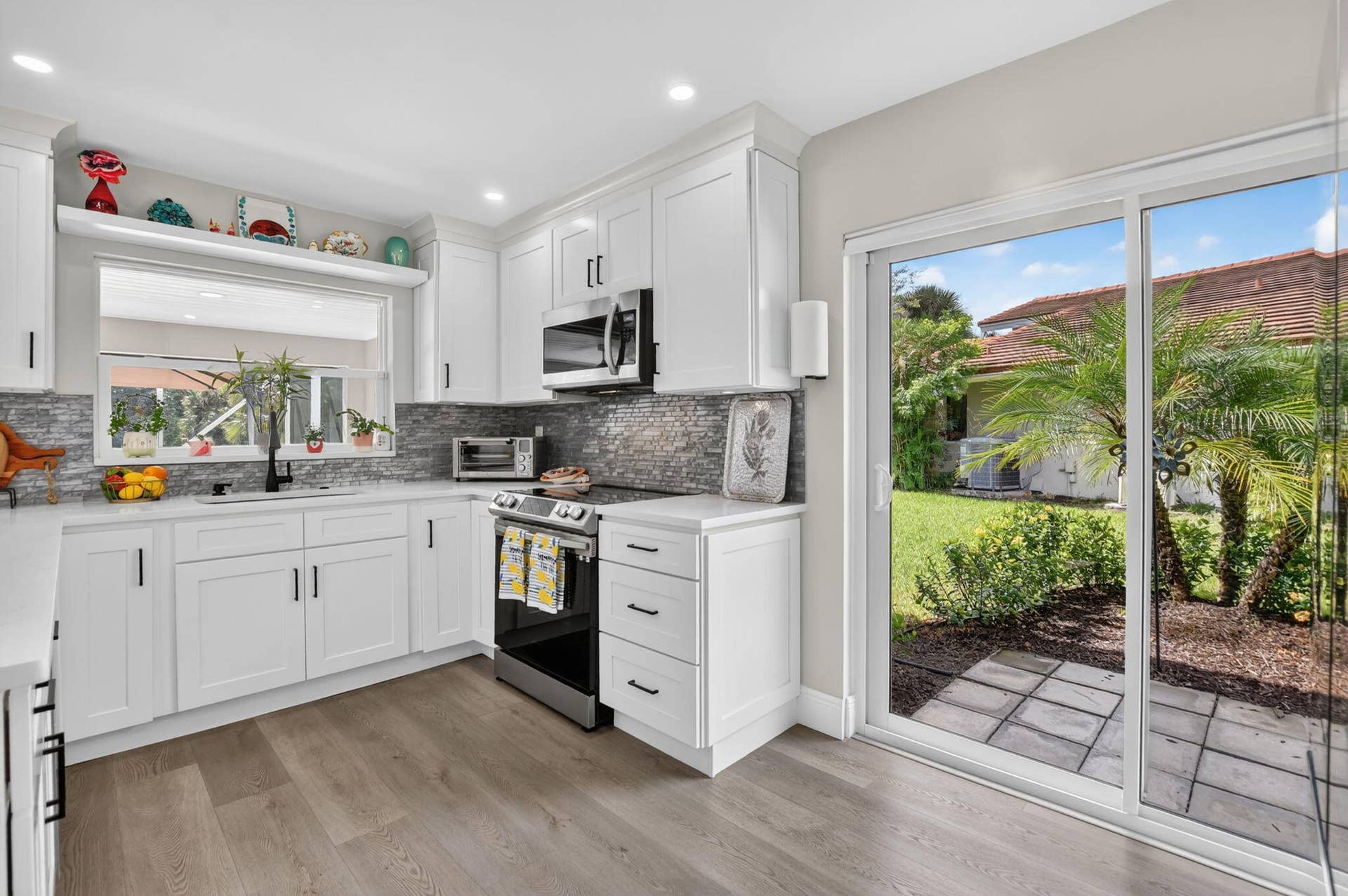 2738 DEER CREEK KELLY BROOKE Lane, Deerfield Beach, FL 33442 Corner location benefits with additional slider to lush green space.