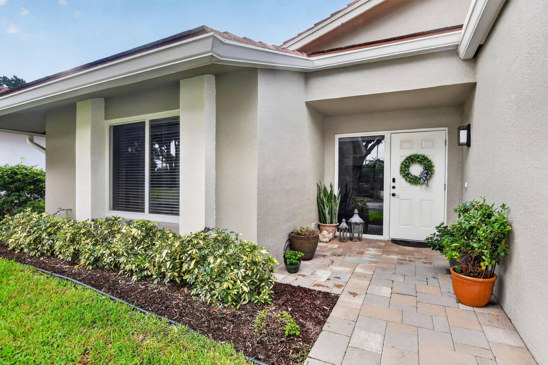 2738 DEER CREEK KELLY BROOKE Lane, Deerfield Beach, FL 33442 Wide paver walkway leads to the welcoming covered entry with double sidelight.