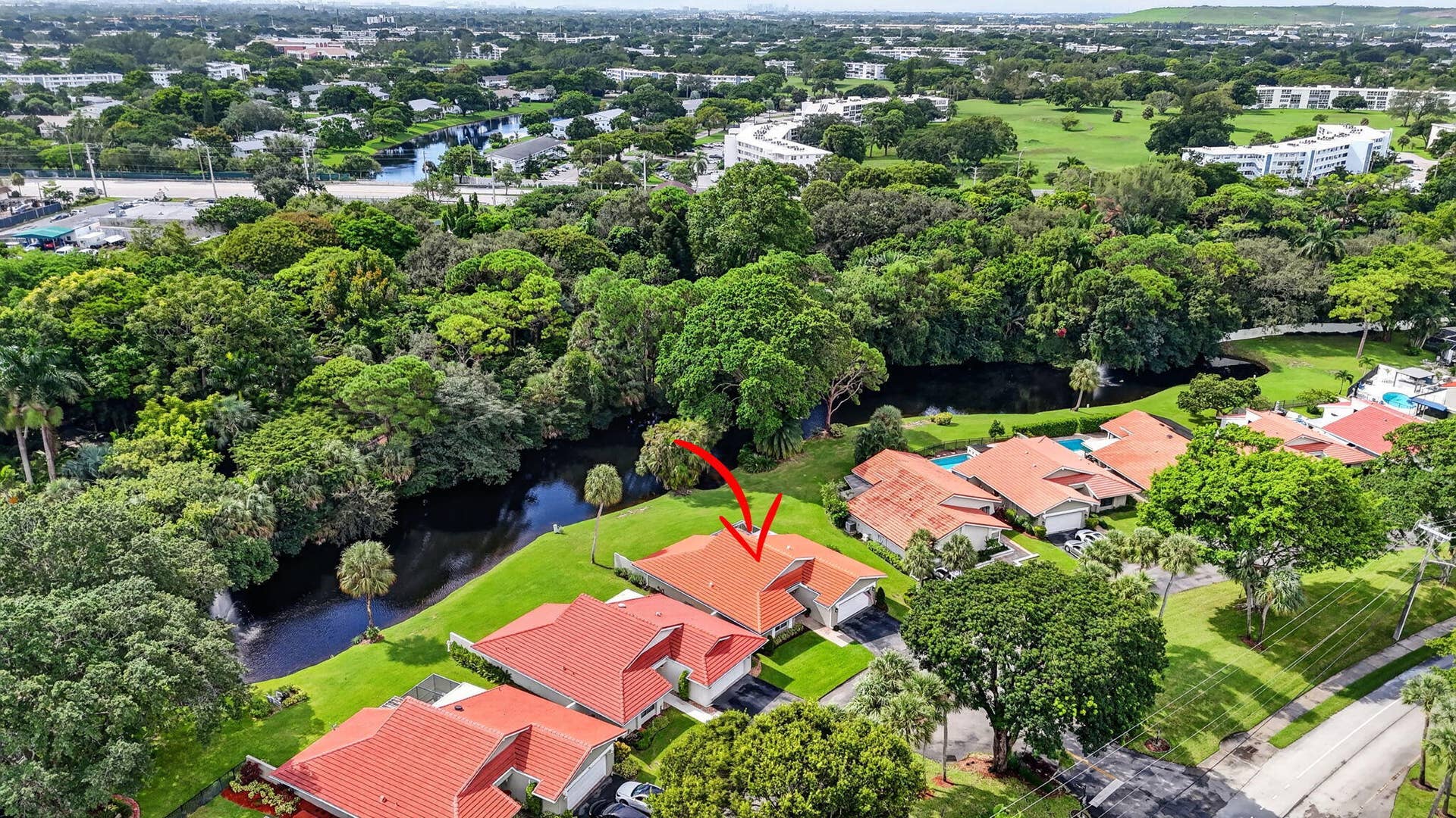 2738 DEER CREEK KELLY BROOKE Lane, Deerfield Beach, FL 33442 Aerial perspective highlights the home's private setting with mature greenery.