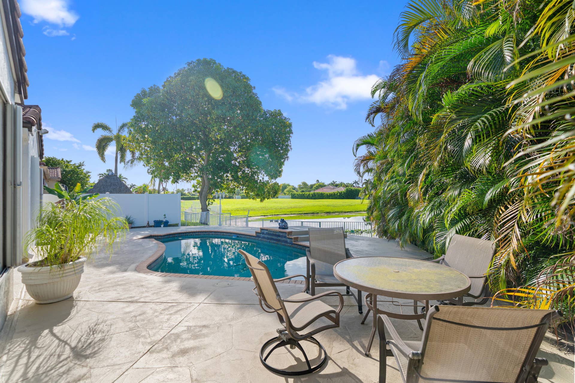 Expansive pool deck provides plenty of room for outdoor dining, lounging and entertaining.