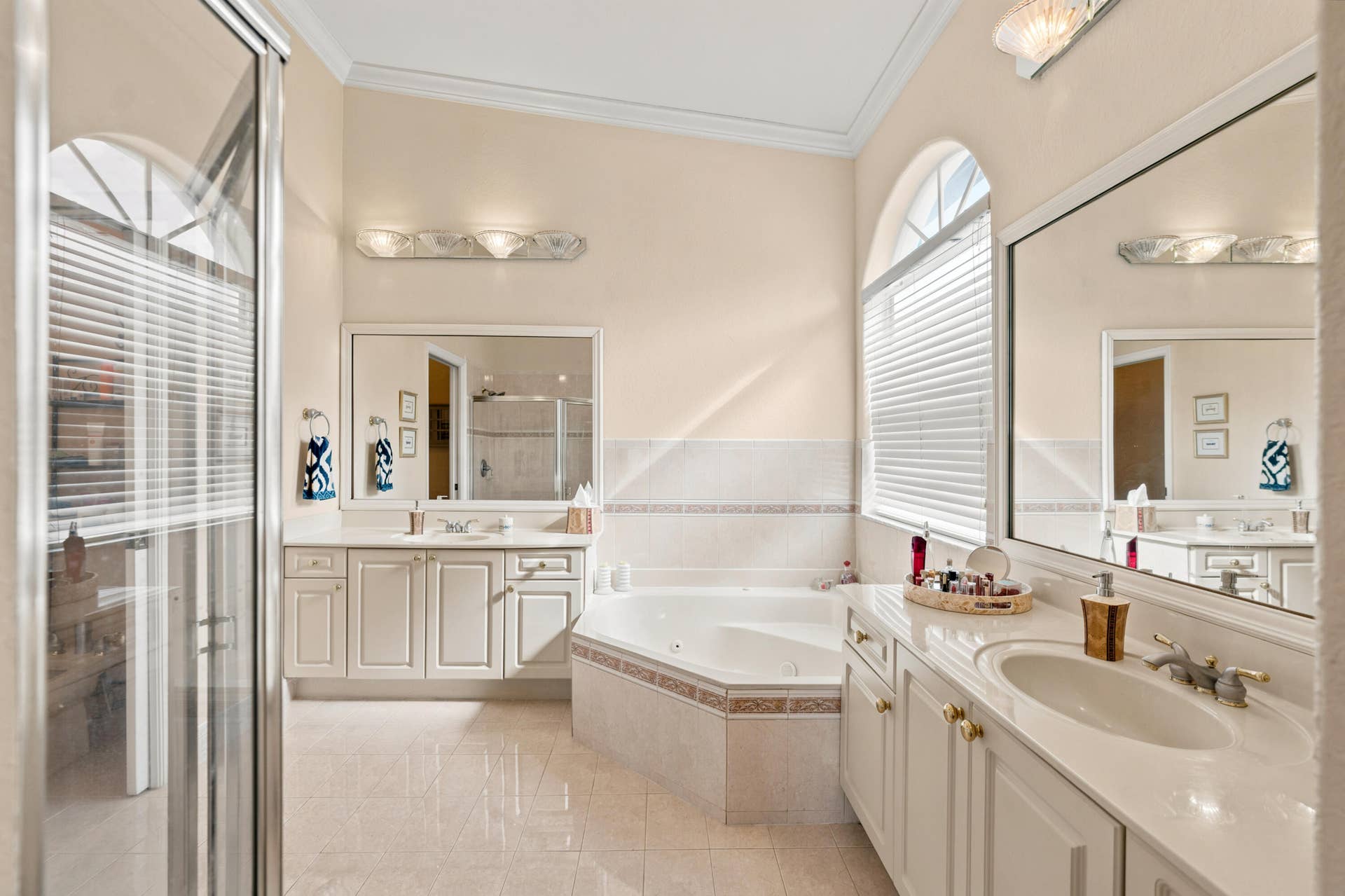 A jetted soaking tub, separate shower and dual vanities create a well-appointed primary bath.