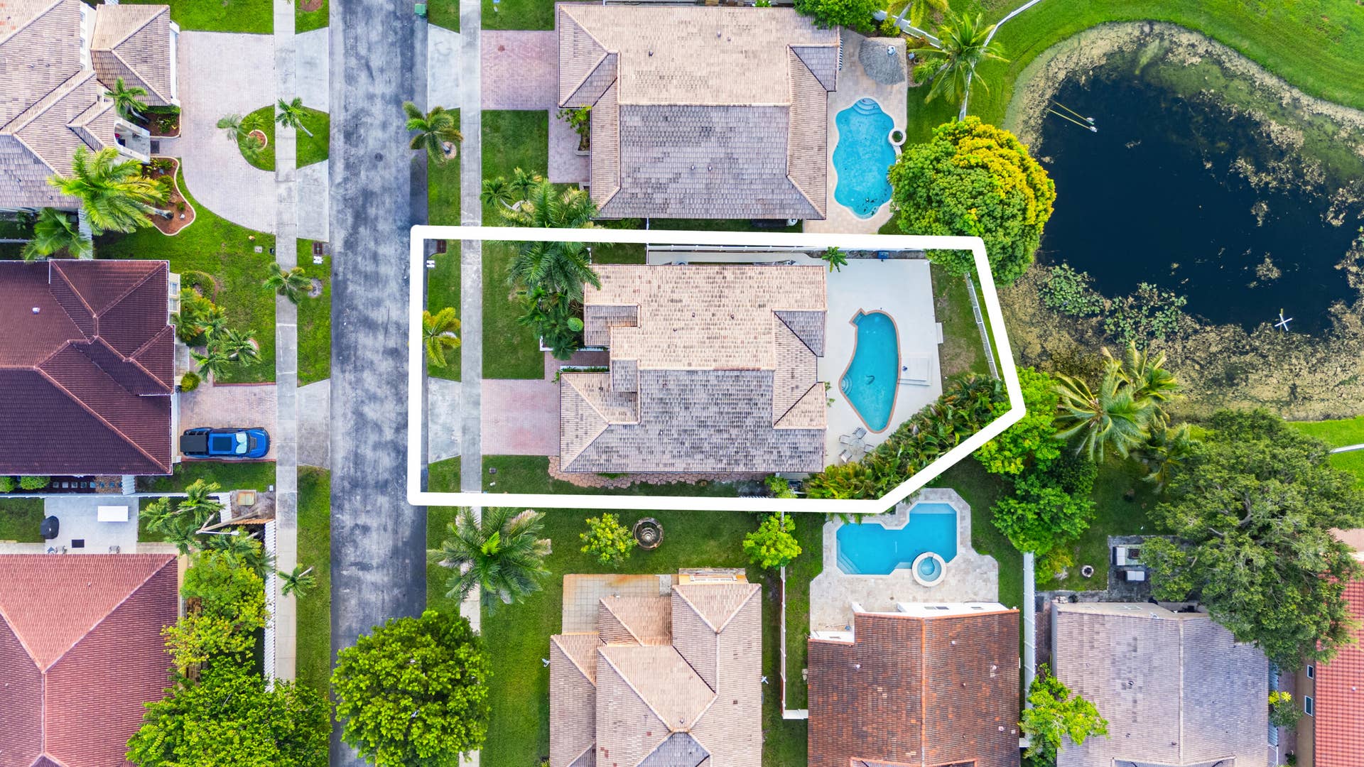 Overhead aerial view highlights the home, private pool and waterfront setting.