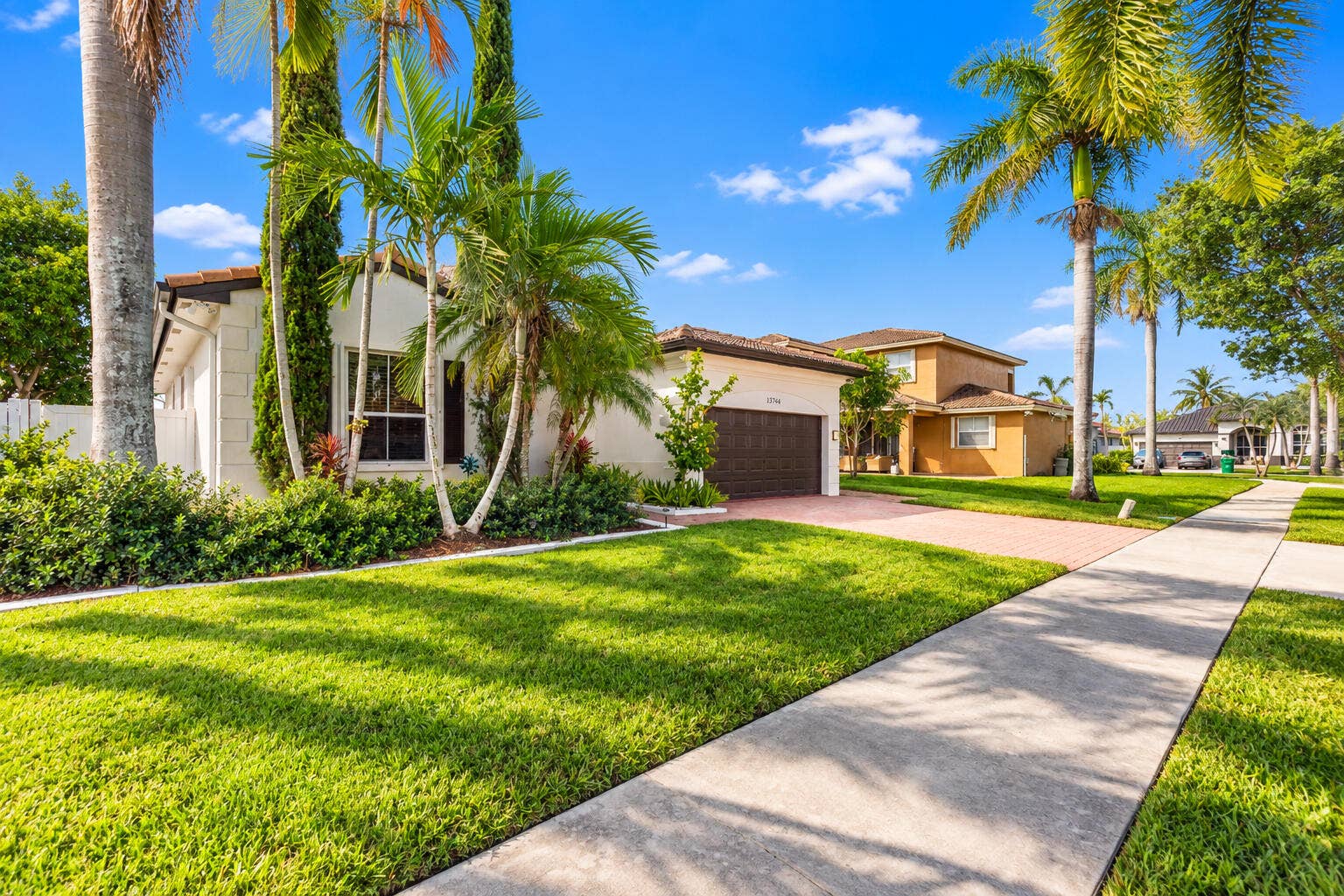Beautifully maintained lawn and mature landscaping enhance the homes curb appeal.