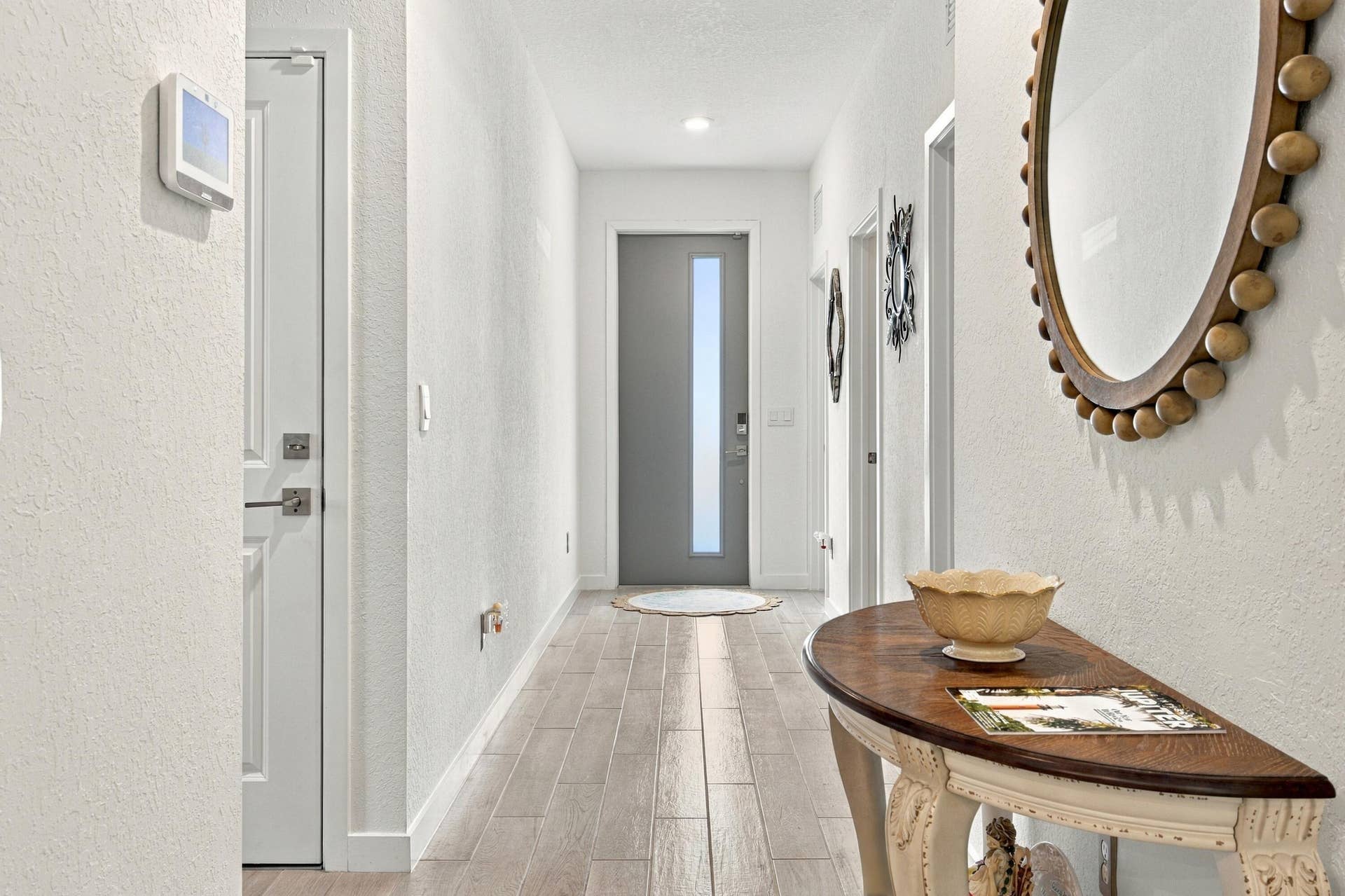 Foyer with beautiful wood luxury wood flooring, recessed lights