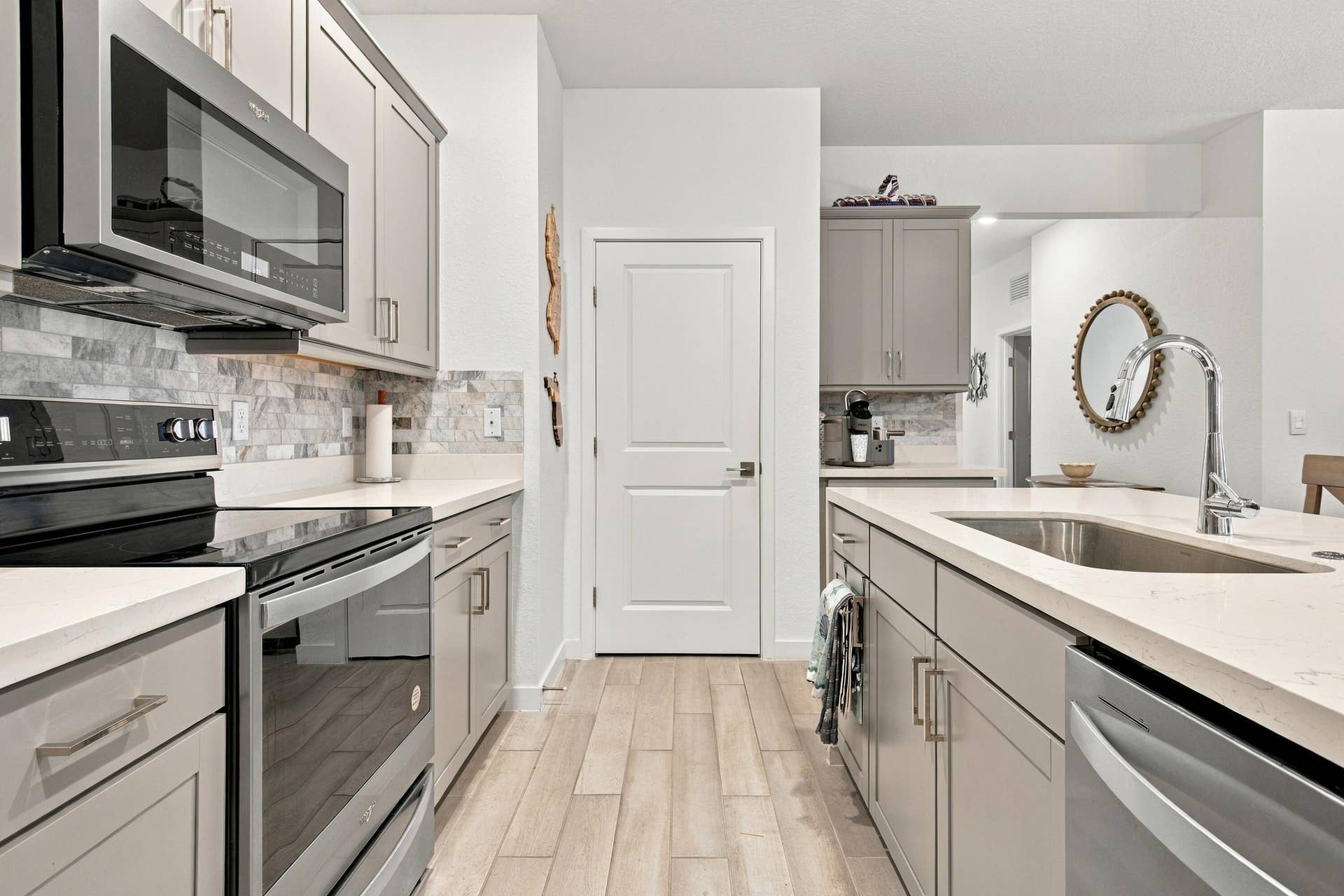 Kitchen with stainless steel LG appliances, customed pantry, stone backsplash