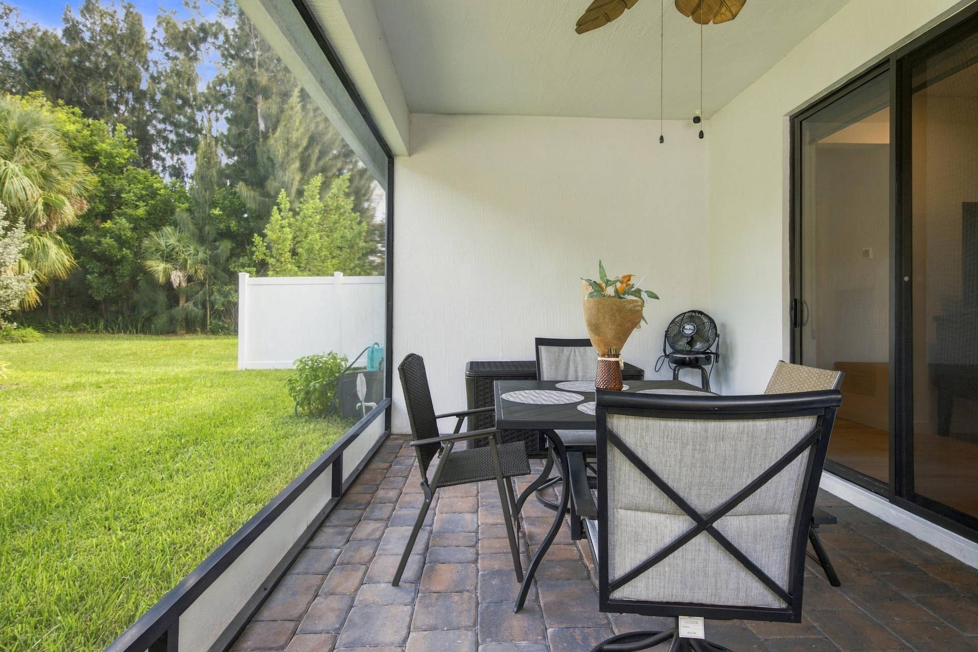 Enclosed Brick paved patio with Ceiling fan.