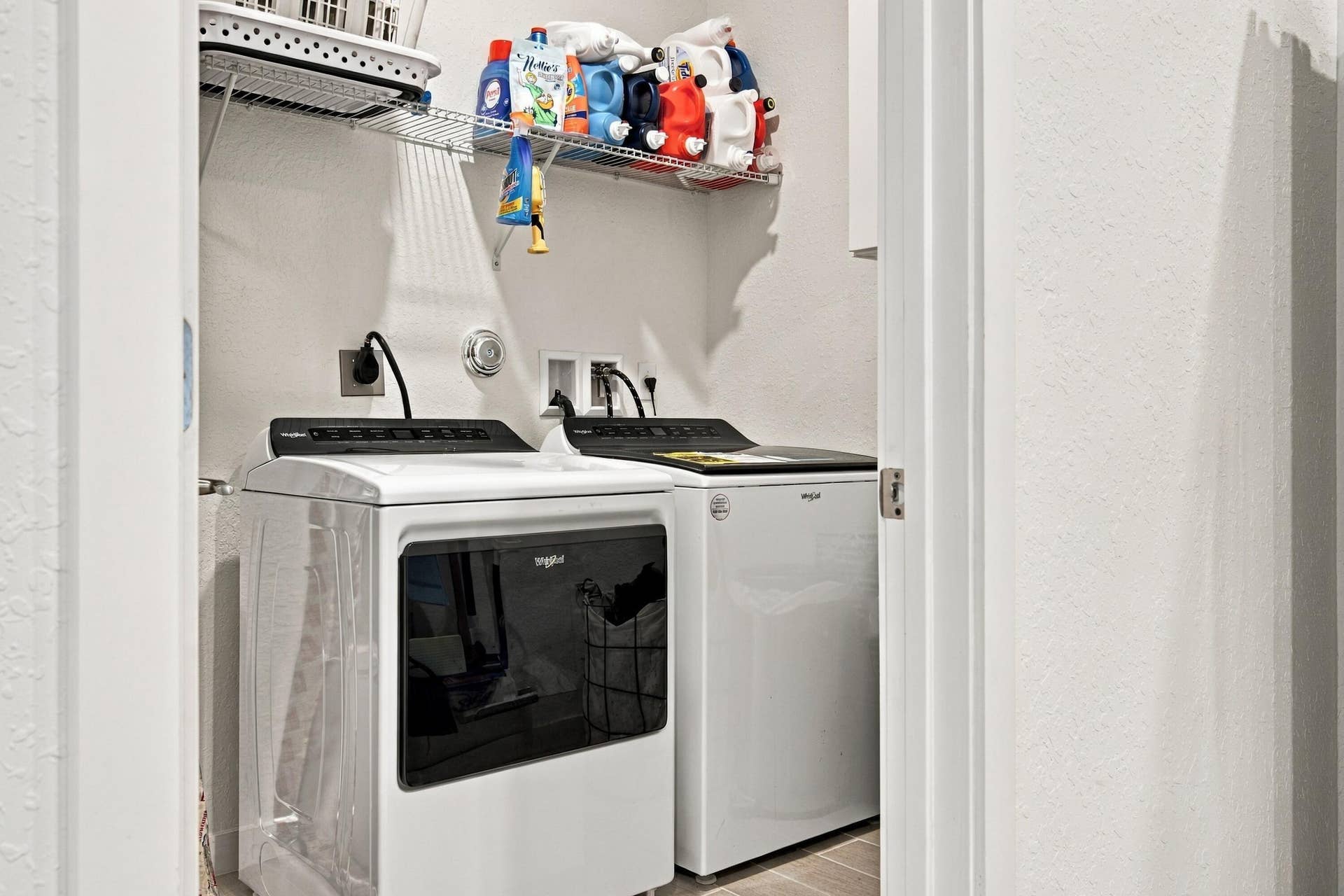 Laundry room with shelves and LG washer & dryer