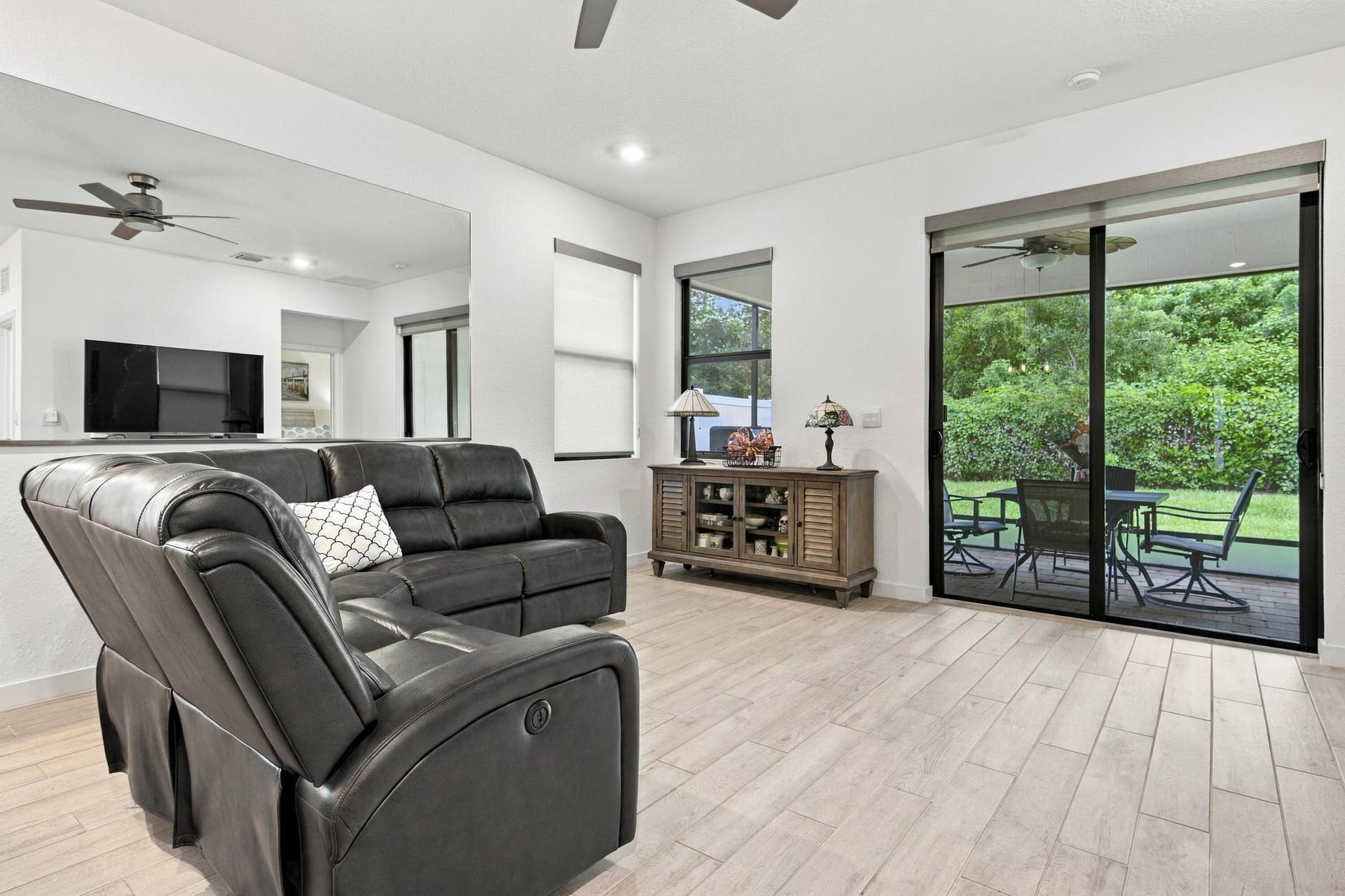 Livingroom with newer ceiling fans, recessed lights, luxury wood flooring
