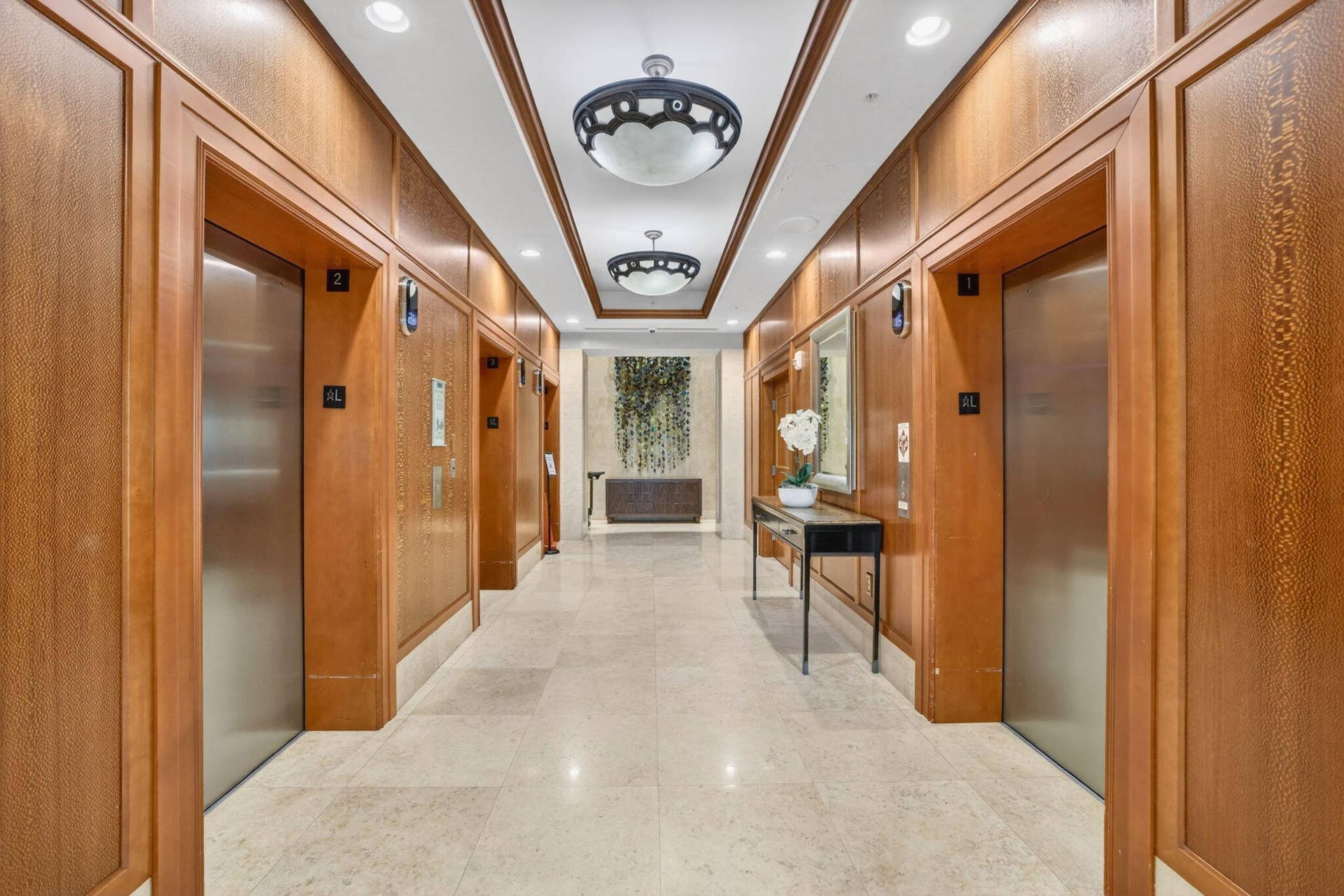 Elevator lobby featuring wood paneling, recessed lighting, and decorative ceiling fixtures